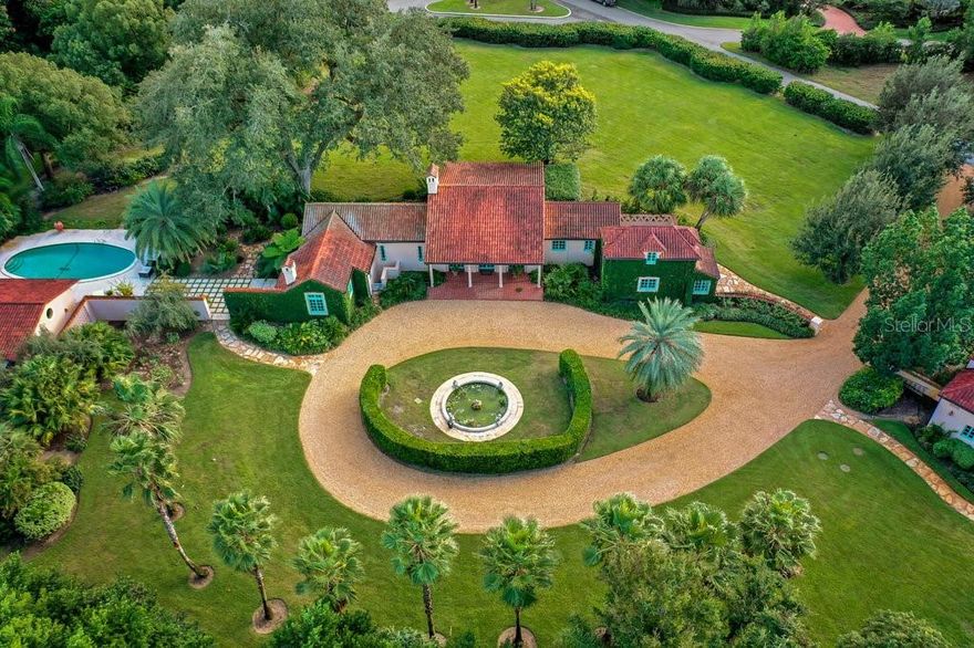 Designed in 1924 by Philadelphia architect Franklin W. Abbott, this enchanting Mediterranean Villa is an owners retreat. Beginning with the stone lined driveway and alluring landscape, be welcomed to this private and peaceful estate with inviting gardens and thoughtful pathways sitting on 3.42 lush acres. The property, which includes many beautiful spaces for soaking in the setting, consists of the main house, a pool house, guest cottage and garage apartment which comprise a total of six bedrooms with six full and two half baths. The main house with wooden and tile floors throughout boasts a grand great room with cathedral ceilings and gas fireplace. It also includes an updated stainless kitchen with all upgraded appliances including Wolf double ovens and range, a Sub-zero refrigerator and Bosch dishwasher. The butler’s pantry with Sub-zero freezer offers plentiful counter and cabinet space, has a convenient powder bath and a separate office attached. The master bedroom wing, which is located on the ground floor, has two walk-in closets, his and her private baths and a private sitting/tv room with fireplace. Additionally, there is a separate ensuite bedroom and bath on the second floor for guests. Whether its lounging or entertaining, if being outdoors is your preference, the 600+- square foot screened-in lanai is perfect for the occasion. The newly reconstructed pool house includes a large great room with gas fireplace, kitchenette, guest suite with full bath, laundry and a half bath. The cozy guest cottage offers two bedrooms, a shared full bath and living room with fireplace. There is also an ensuite guest apartment above the garage currently used as an exercise room but could easily be an overflow suite for guests. The details of this home and property are unmatched with many countless upgraded features including but not limited to a separate Rinnai instant hot water system and Geo-thermal heating and air conditioning systems for each building. There are also many citrus and fruit trees on the property including lemons, limes and avocados. This is truly an exceptional historic home with amazing details throughout and your opportunity to own this beautiful estate!