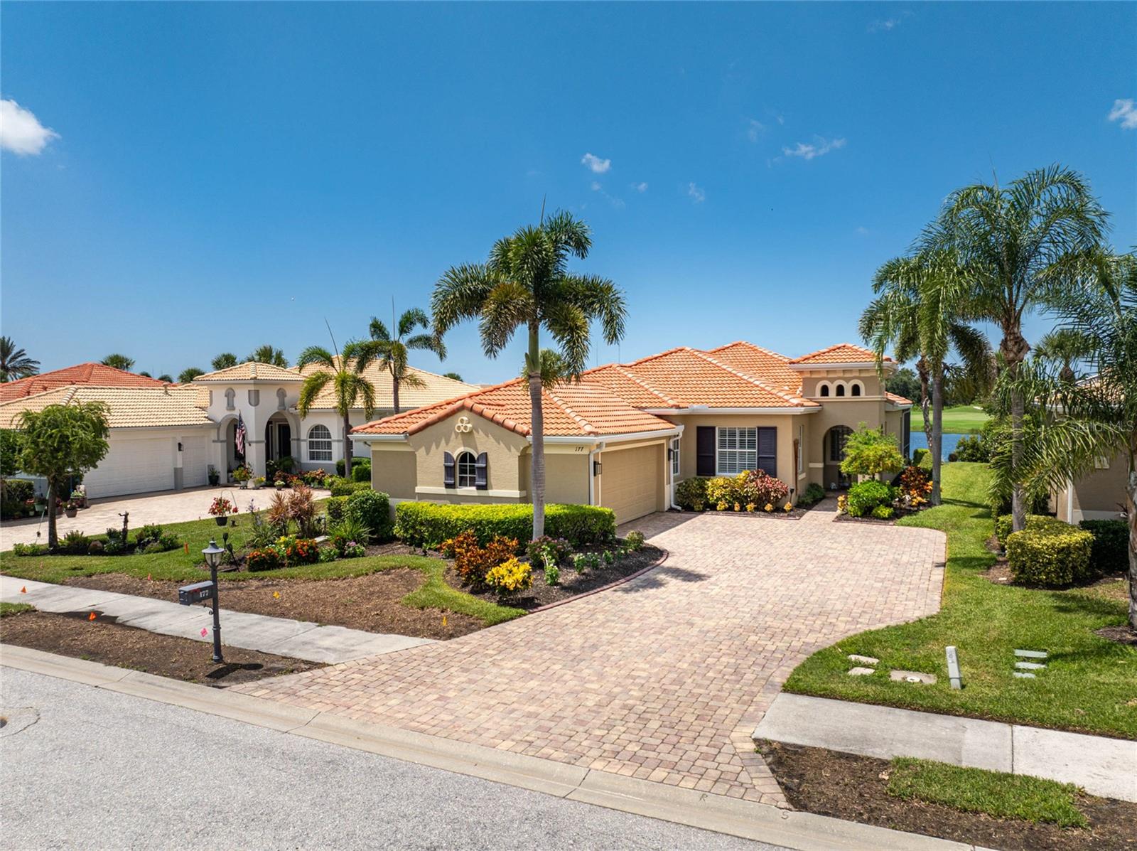 Welcome to paradise at the Venetian Golf and River Club! Stunning home offering a spectacular lifestyle within a gated golfing community with absolutely STUNNING WATER VIEWS AND GOLF COURSE beyond! You'll be captivated by the uninterrupted, panoramic views of the lake and the 18th fairway, perfect for watching gorgeous sunsets from your living room or your luxurious, large, heated saltwater pool. The extended lanai is protected by electric roll-down shutters, and the home features hurricane-impact glass windows and hurricane shutters for peace of mind. Inside, the home exudes tranquility with tile flooring in the common areas and vinyl flooring in the bedrooms. Soaring tray ceilings and crown molding enhance the open feeling in this WCI built Dolci Model. The kitchen is a chef's delight, recently redone with abundant cabinetry, counter space, breakfast bar, stainless steel appliances, and quartz countertops. The side-load garage and the well maintained home will add to your convenience and comfort. The Ventian Golf and River Club is a vibrant, gated community that offers resort-style living at its finest. Enjoy an array of amenities, including a championship 18-hole golf course, a six-court Har-Tru Tennis Center, pickleball courts, lap and resort pools, a cabana bar, a fitness center, and a wide variety of planned social activities. You can also take a peaceful stroll along the Riverwalk, which winds through a 70-acre nature park teeming with Florida's exotic birds and wildlife.