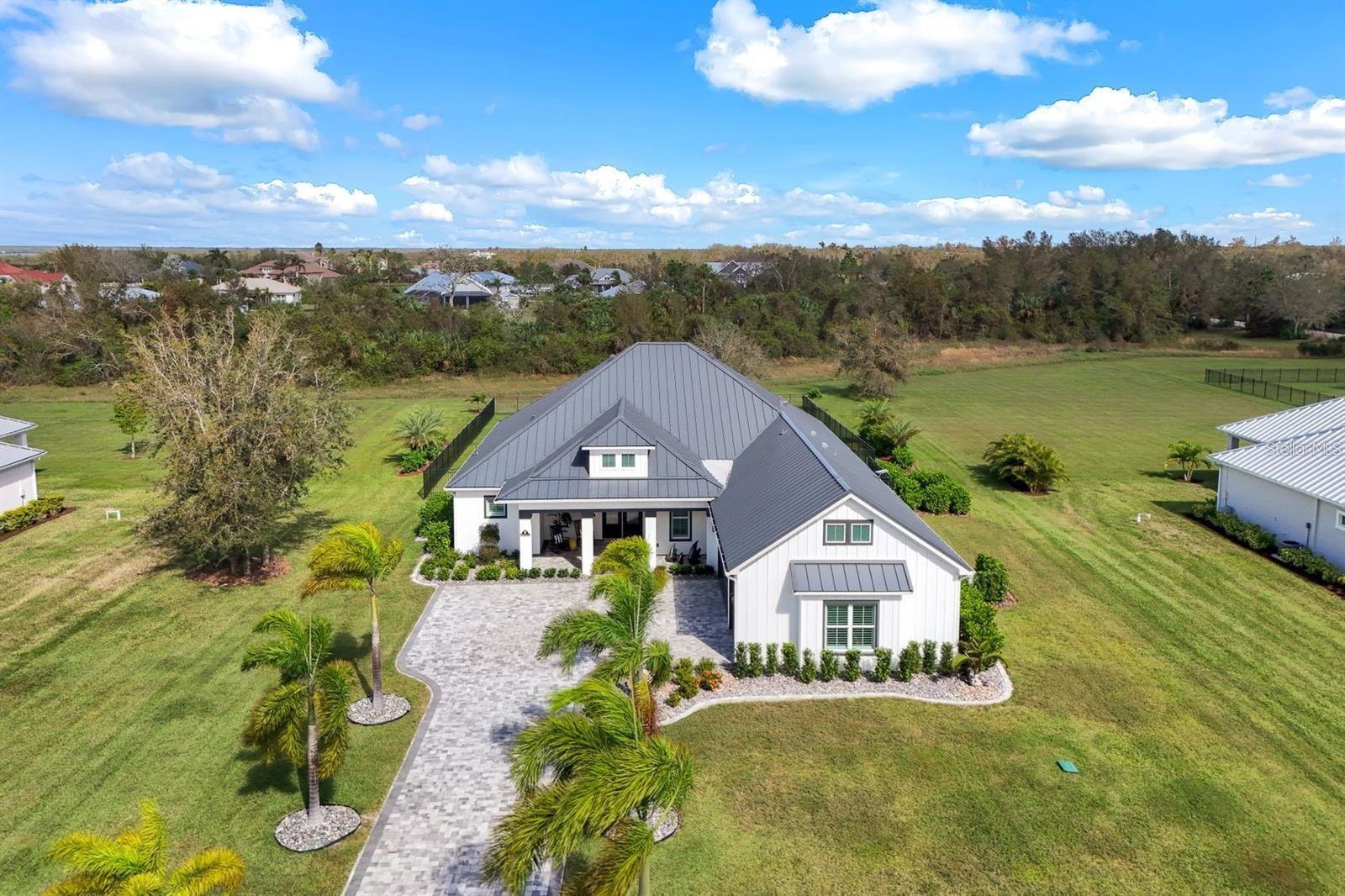Welcome to 28984 Gin Ln, a meticulously maintained, move-in ready home nestled in a small, quiet gated riverfront community of The Estates of Peace River Shores. Located on a private 1.14 acre lot at the end of a cul-de-sac, this exceptional property offers direct Gulf access via the Peace River and includes a deeded boat slip with a 13,000 lb lift, complete with water and electric—perfect for boating enthusiasts. This home is truly one of the finest in the development, loaded with high-end upgrades and designed for comfort, style, and security. Interior highlights include great room floorplan with ceramic tile throughout striking custom accent wall with a built-in fireplace, gorgeous gourmet kitchen with luxurious Level 5 granite countertops, Top-tier Bosch appliances, butlers pantry, elegant plantation shutters throughout, impact windows for peace of mind plus a powerful 24kW Generac whole-home generator. 10-camera security system for enhanced safety and High-speed connectivity via Starlink Satellite Internet and Whole-house reverse osmosis (RO) water system, Outdoor living is just as impressive, featuring a huge propane-heated pool & spa with sun shelf, beautiful screened lanai with full outdoor kitchen, ideal for entertaining. This home combines upscale finishes, peaceful surroundings, and premium functionality—offering a rare opportunity to enjoy luxury waterfront living with direct access to Charlotte Harbor, downtown Punta Gorda Entertainment & Dining and the Gulf of Mexico. Don’t miss your chance to own this move-in ready masterpiece with all the upgrades already done. Schedule your private showing today and discover this unmatched value. You won't find a nicer home with water access for the price anywhere in SW Florida!
