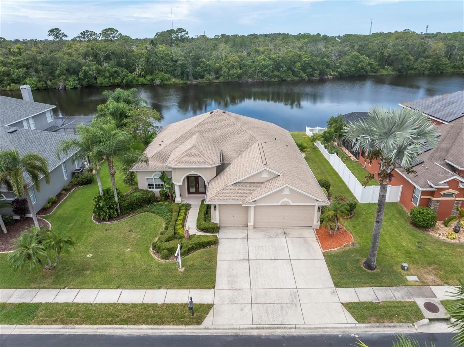 One or more photo(s) has been virtually staged. Waterfront Elegance in the Heart of Trinity! At this price, it wont last. Welcome to your Florida dream home in one of the most sought-after gated communities in the Trinity/New Port Richey area — where every day feels like a vacation! This stunning 4-bedroom, 3-bath, 3-car garage pool home is perfectly perched on the water with peaceful conservation views and no rear neighbors — offering you the ultimate in privacy and serenity making this one of the most premium desired lots in the whole community.
Inside, you'll be greeted with over 11 feet of soaring ceilings, smartly designed tri-split floor plan that offers both functionality and privacy for the whole family. The heart of the home features a spacious eat-in kitchen adorned with rich solid wood cabinetry and gorgeous granite countertops, perfect for cooking up memories. Entertain in style with a formal dining area, a welcoming living room, and a versatile great room — there's space for everyone and everything!
Step outside to your personal paradise: a sparkling screened-in pool (just resurfaced) overlooking tranquil waters and lush conservation land. Unwind in the evenings with a front-row seat to breathtaking sunsets from your very own backyard. You will find an extended lanai outside the screens completed with pavers and a fire pit for those cooler cozy nights. Roof 5 yrs new.
BONUS: This exclusive community offers a private community boat ramp, playground and park area, perfect for weekend adventures on the water! Zoned for A-rated schools, No CDD fees, Low HOA, No flood insurance required
Conveniently close to hospitals, top-rated restaurants, shopping, and just 15 minutes from the beach!
Don't miss your chance to own this slice of Florida paradise — homes like this don’t come around often!