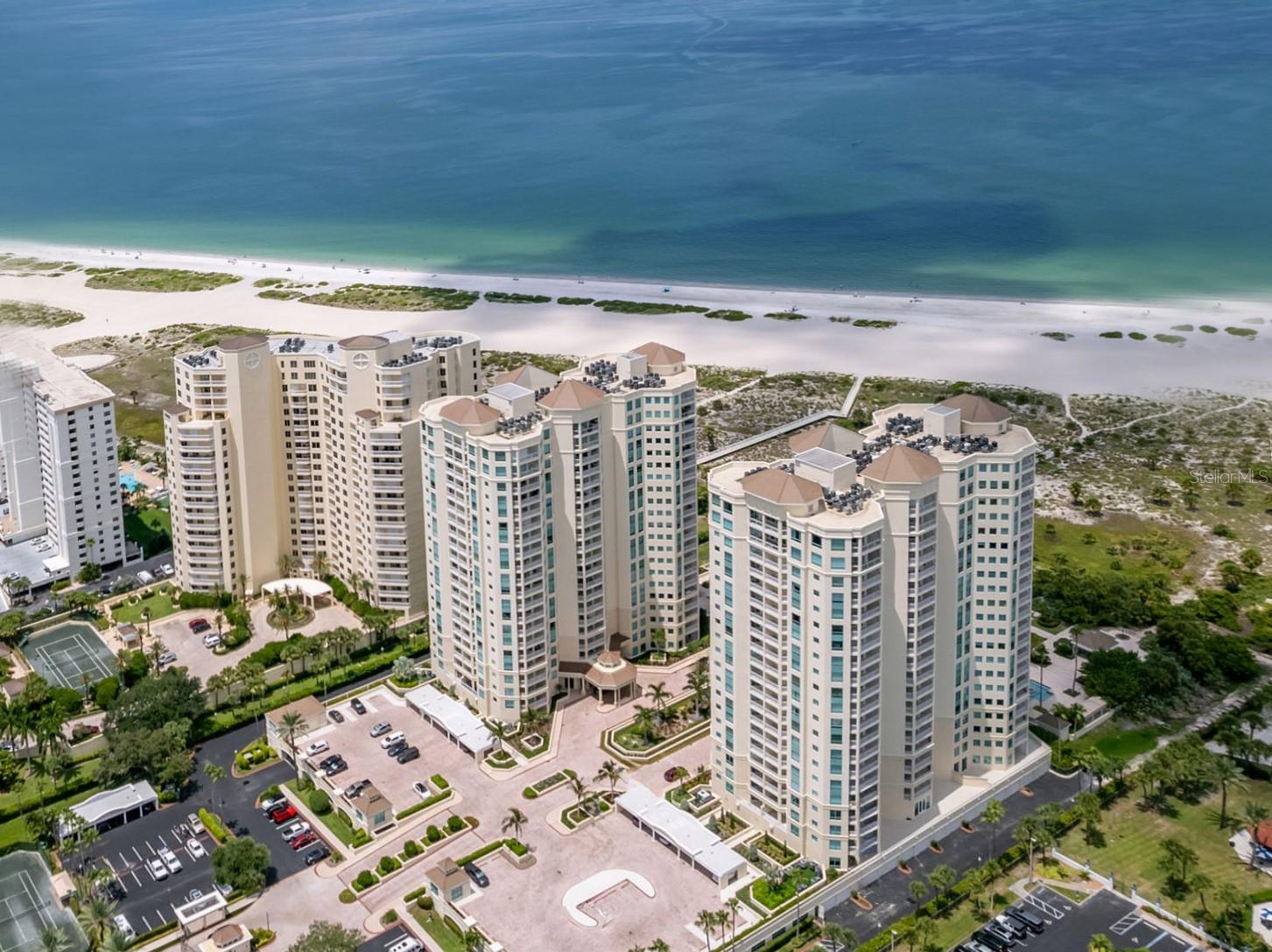 Nestled within the impressive 14-acre gated Grande on Sand Key, this exquisite residence on the 5th floor offers a refined living experience. This condo features 2 bedrooms and 2 baths of thoughtfully designed interior space, with a beautiful TERRACE that provide captivating Northwest and Northeast views. **** Enjoy stunning GULF VIEWS, and breathtaking vistas of Clearwater Harbor to the north and east. **** The interiors are designed with a timeless modern elegance. Upon entry the eye captures beautiful new flooring, refined paint treatments, a custom kitchen, designer lighting, completely remodeled baths with exquisite porcelain finishes, high end vanities with lighted mirrors, with frameless shower doors. **** Also included, underbuilding parking space (176, a premium location) and storage unit #21. **** The building has recently undergone MAJOR RENOVATIONS which include: New building envelope paint and seal, all windows caulked and resealed, New expansion joints put in, New water barrier put on, All planters resealed, Brand new landscaping. New security gate all around the property. **** New added GATED ACCESS from the amenities deck to the Sheraton nearby if you want to hop over next door to for a snack at the Poolside Cafe or drinks at Slo Joe's Turtle Bar. **** The amenities are wholly reminiscent of a WORLD CLASS RESORT with multiple pools, tennis courts, social rooms, canopied poolside cabanas, fitness centers with steam and sauna and last, but certainly not least 24 HOUR GUARD GATED security and concierge services (Concierge Mon-Fri).
