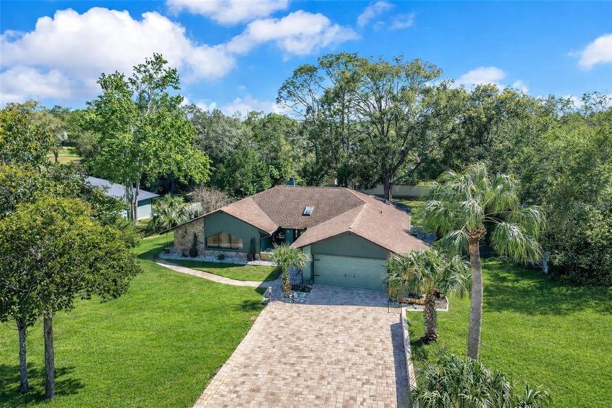 Welcome to River Country—where space, style, and thoughtful updates come together. Set on a generous half-acre in the heart of Spring Hill, this beautifully updated home offers a rare combination of privacy, functionality, and modern finishes.

Step inside to a bright, open layout featuring 4 bedrooms and 2 baths, designed for both everyday living and effortless entertaining. The spacious kitchen and living area serve as the heart of the home, complete with a cozy wood-burning fireplace—perfect for gathering and relaxing. The split floor plan provides flexibility and separation, with the primary suite and 4th bedroom/bonus room on one side, and two additional bedrooms on the other.

The kitchen has been tastefully upgraded with modern cabinetry, updated countertops, and newer appliances, all overlooking the backyard through sliding glass doors that invite in natural light and create a seamless indoor-outdoor connection.

Outdoors is where this property truly shines. Enjoy extensive paver upgrades, including a beautifully finished driveway, walkways, and a dedicated fire pit area—ideal for entertaining, relaxing evenings, or hosting guests year-round. The half-acre lot provides plenty of room to spread out, with space for vehicles, hobbies, or additional outdoor features.

Additional highlights include an oversized garage, ample parking, and a layout that offers both comfort and versatility.

Conveniently located near shopping, dining, schools, and major roadways, this home offers a balance of peaceful surroundings with easy access to everyday essentials.

If you’ve been looking for an updated, move-in ready home with space to enjoy—this is one you won’t want to miss. Schedule your private showing today.