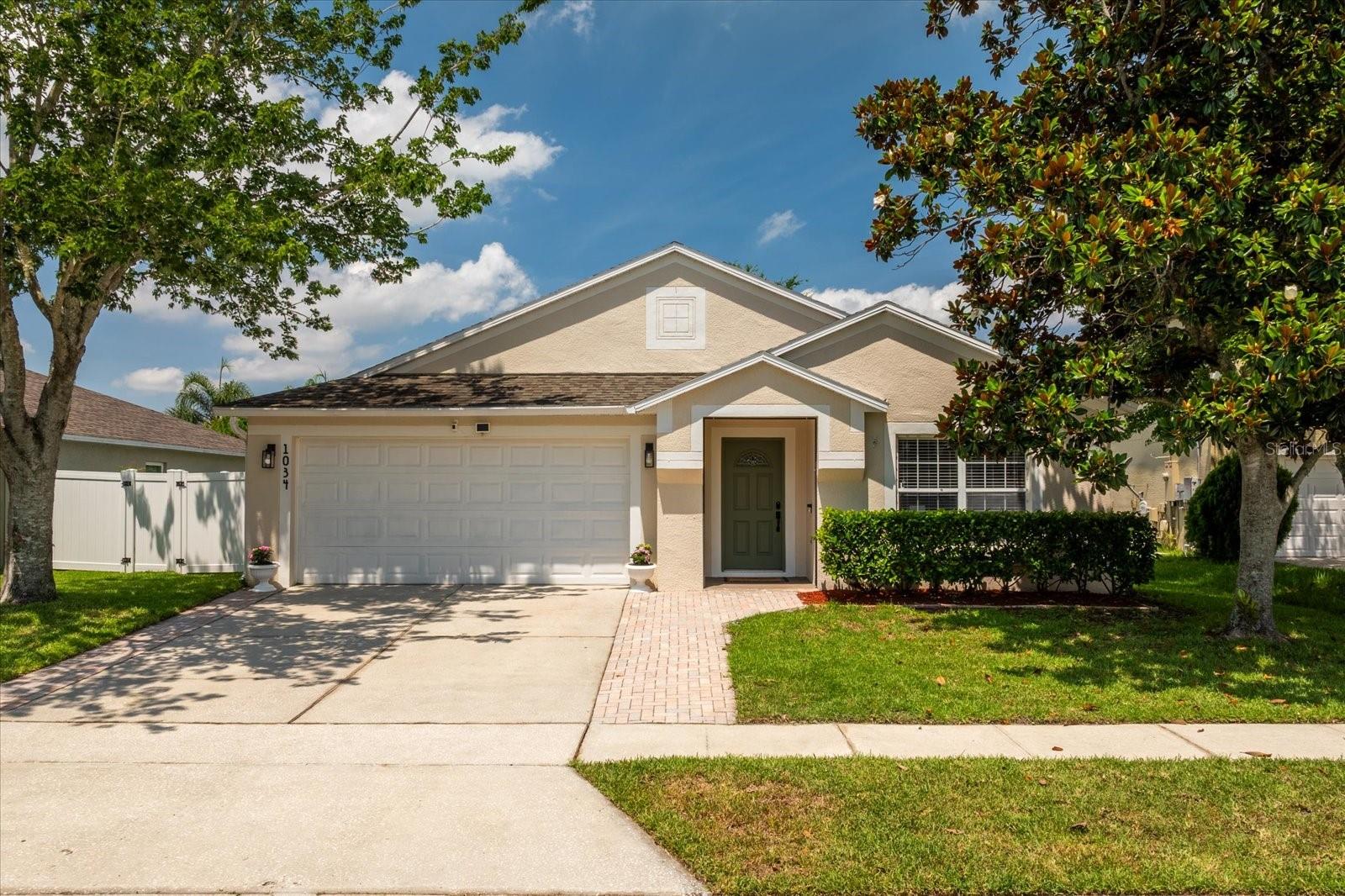 Welcome home to 1034 Seneca Falls Dr - A beautiful 4-bedroom, 2-bath pool home in the gated community of Glenmore Chase at Waterford Chase East. Perfectly designed for families, this spacious home features an open floor plan, stunning Brazilian Teak hardwood floors, and sits just minutes from UCF and zoned for top-rated schools. The thoughtful 3-way split floor plan enhances privacy and functionality, while catering to a variety of lifestyle needs. The heart of the home is the oversized kitchen, offering real wood cabinetry and plenty of storage - perfect for busy mornings and family gatherings. Sliding glass doors lead to a private fenced in backyard where you'll find a huge sparkling pool, paver-lined deck, and play set, a true backyard paradise for both kids and adults! Community perks include a playground, dog park, tennis courts, and basketball court, making it easy to stay active and connected. Recent updates include Roof (2018), A/C (2020), New fence (2024). Located minutes from shopping and dining, UCF, Valencia, Research Parkway, Lockheed Martin, and major highways (SR 408, 417 & 50). This move-in-ready home checks all the boxes for location, lifestyle, and long-term value. Priced to sell. Schedule your private showing today and give your family the home they deserve!