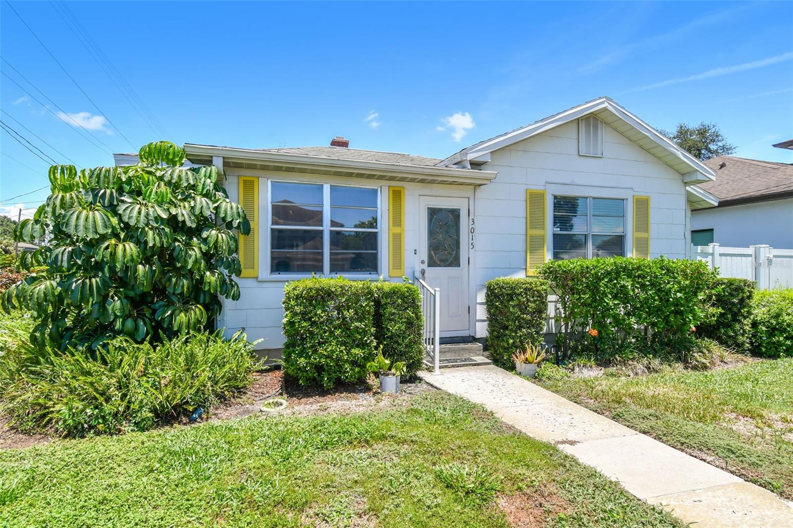 Located on a 61' x 97' corner lot at MacDill Avenue and W North B Street, this South Tampa property presents an excellent opportunity for a custom new build or full renovation. Being sold as-is for seller convenience, this offering is best suited for cash buyers seeking a prime location just minutes from Hyde Park, South Howard, and downtown Tampa.
The existing 3-bedroom, 2-bath home offers 1,469 square feet of living space and has been well maintained, with a roof replaced within the last four years. Inside, you’ll find a warm, functional layout that includes a sunroom-style front porch, a family room that opens to the kitchen, and a separate living room with wood-paneled walls, built-in storage, and access to the backyard. The kitchen features solid wood cabinetry, solid surface countertops, bar seating, and a casual dining area, along with access to the laundry room and side yard.
The primary bedroom includes built-in closet space and an ensuite bath with walk-in shower, while the secondary bedrooms offer flexibility for guests, home office, or creative space. Outside, the home includes a private driveway, carport, and storage shed, surrounded by a landscaped yard.
Whether you’re looking to build new or bring your vision to life through renovation, this property offers incredible potential in one of Tampa’s most desirable neighborhoods.