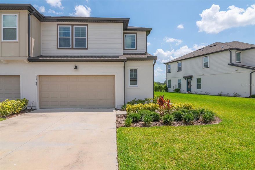 Stunning CORNER UNIT Townhome in the heart of ChampionsGate! This beautifully maintained 3-bedroom, 2.5-bath townhome offers over 2,100 square feet of stylish, functional living space with a light and airy feel throughout. As you step inside, you're welcomed into a spacious open-concept great room filled with natural light, highlighted by tile flooring and a modern, neutral color palette. The gourmet kitchen features quartz countertops, an oversized island with seating, tons of cabinet and counter space, and sleek stainless steel appliances—perfect for both everyday living and entertaining. A short hallway leads to the two-car garage, a half-bathroom, and a versatile nook area that’s ideal for a small desk or mail and key drop zone. Storage is plentiful in this unit with a large under-stair closet and an oversized coat closet. Upstairs, the spacious primary suite boasts an expansive walk-in closet and an en-suite bathroom complete with dual vanities and a fully tiled shower with upgraded frameless glass. Two generously sized guest bedrooms share a unique Jack-and-Jill-style layout, each with its own private vanity and a shared bath and toilet area—offering both privacy and convenience. A large second-floor laundry room located near all the bedrooms adds to the home’s thoughtful design. Step outside to a private patio where you can relax and enjoy the scenic natural surroundings of the lot. Approximately 20 minutes to Disney World!!! Located just minutes from world-class golf, shopping, dining, and all that ChampionsGate has to offer—this home truly has it all! Schedule your private showing today.