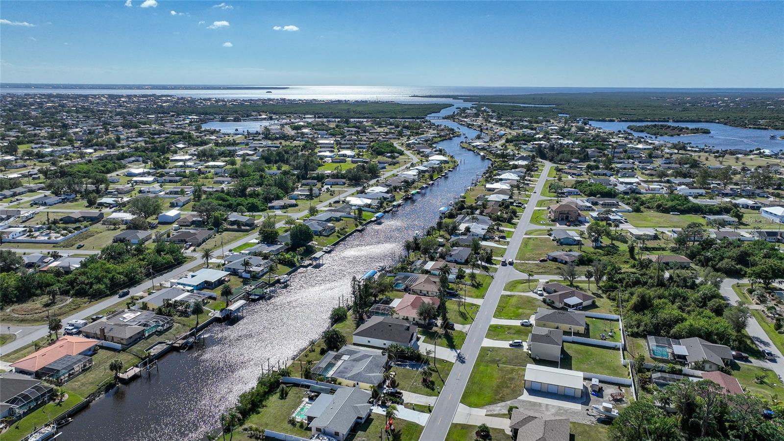 Gorgeous WATERFRONT 4 bedroom plus Den, 3 bathrooms , 3 car garage and is on public water & sewer.. Upon entering this LARGE home, your eyes are immediately drawn to the expansive canal in back with a concrete seawall alaready in place. You will love cooking in your kitchen with granite countertops, white cabinets, all stainless steel appliances and a beautiful breakfast bar. There is plenty of room to entertain guests as there is a large great room, eating space in kitchen and a seperate Dining Room. The whole house is tiled for easy clean ups. The lay out of this home is perfect as you have a master suite that is seperate from the other bedrooms. There is also another master suite on the other side of this home. Working from home is not a problem as there is a private office as well. And for the car enthusiasts, there is a 3 car garage. This home also has access to Charlotte Harbor and Is only 1 mile to a public boat ramp (until you build yours) There is also plenty of room to build a pool! The cute city of Punta Gorda is only a few miles away as is the new Sunseekers resort. Don't miss seeing this home in person. There is also a 3D tour attached to this listing.