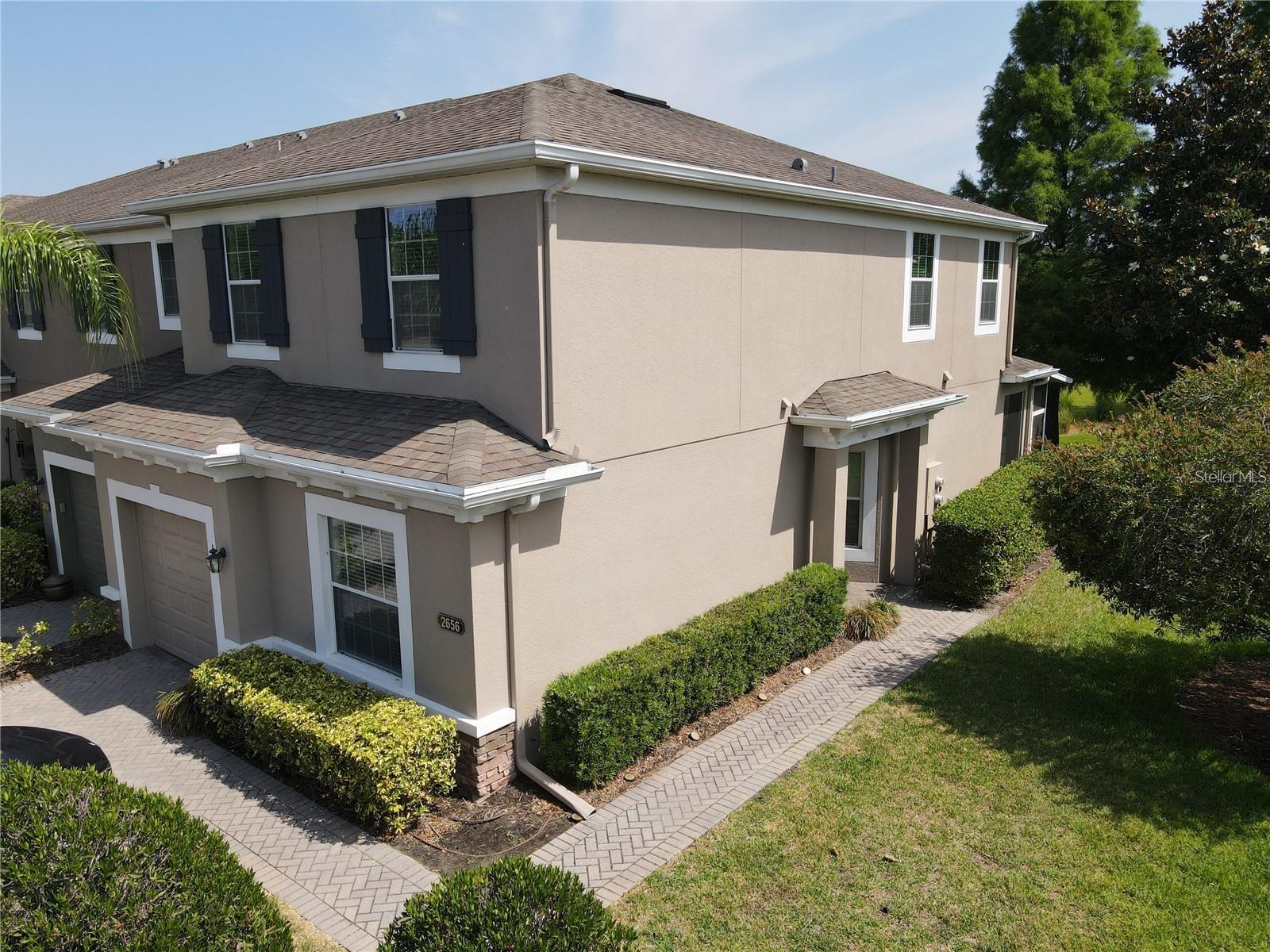 Beautiful three-bedroom, three-bathroom townhome, a coveted CORNER unit, overlooks a picturesque pond. Upon arrival, you will be greeted by charming curb appeal, featuring a two-car paver driveway, a one-car garage, and a paver walkway that leads to a covered front entrance surrounded by manicured landscaping. Step inside to discover tile flooring and decorative chair rail molding throughout the main living area. The great room, with its open floor plan, is designed for effortless entertaining. The kitchen is equipped with stainless steel appliances, smooth granite countertops, pantry, and a breakfast bar, perfect for casual dining and enhanced by pendant lighting. The first-floor den provides a private space ideal for work or study. Ascend the stairs to find brand-new carpeting throughout the second floor. The spacious primary bedroom is bathed in natural light and features a walk-in closet, along with an ensuite bathroom complete with dual sinks, shower, and a separate garden tub for unwinding after a long day. Additionally, there are two generously sized bedrooms to take advantage of. A conveniently located interior laundry room with washer and dryer hookups to complete necessary chores. Don't overlook the covered, screened enclosed patio that offers an inviting space to enjoy fresh air while taking in the serene view of the pond. This townhome is located within the gated community of Riverview Townhomes, which offers a sparkling community pool, park, playground and private access to the Sanford Sunrail station. It is conveniently situated near downtown Sanford, Sanford Riverwalk, Marketplace at Seminole Town Center, I-4 and 417 access, providing ample opportunities for shopping, dining, and entertainment. This fantastic townhome is waiting for you!