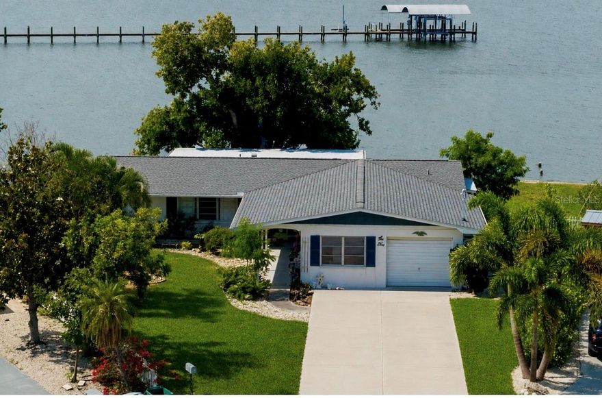 Welcome to one of Palmetto's most unique waterfront opportunities. Situated on a rare oversized point lot with more than 150 feet of seawall, this 3-bedroom, 2-bath home offers a setting that is nearly impossible to replicate. Located at the end of a canal with direct views of open water and no rear neighbors, the property captures breathtaking sunsets, expansive river views, and a sense of privacy that is seldom found along the waterfront.

With approximately 2,300 square feet of living space, the home features a spacious split-bedroom floor plan, generous living areas, and a large covered patio designed to take full advantage of the spectacular waterfront backdrop. The solid block construction and recently replaced roof provide a strong foundation for future improvements, while the expansive yard offers endless possibilities for outdoor living, entertaining, or the addition of a private dock.

Owned by the same family for more than 50 years, this property is now ready for its next chapter. While the interior reflects years of cherished ownership and will benefit from updating and renovation, the layout, size, and exceptional location create an incredible opportunity to customize the home to your own taste and vision.

Whether you're looking to renovate, create your dream waterfront retreat, or invest in one of the area's most desirable waterfront settings, opportunities like this are few and far between. Endless water views, unmatched privacy, over 150 feet of seawall, and a premier location make this a truly special property.
