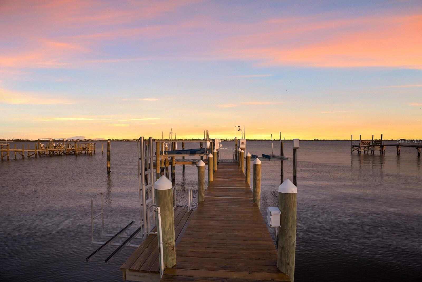 Welcome to an unparalleled waterfront sanctuary on exclusive, historic Terra Ceia Island, a residence where refined luxury meets tranquil allure of coastal living. Designed by the acclaimed Emily Anne Smith and remolded by Ross Built Construction, this estate offers an exquisite blend of sophistication and serenity, making it a haven for discerning buyers who value boating and privacy. Set on just shy of an acre with 155 feet of water frontage, this property is a boater’s dream. A 222-foot dock, equipped with three Golden Lifts, one for a vessel up to 8,000 pounds and two for jet skis up to 5,000 pounds, along with a dedicated mooring slip, ensures seamless access to Tampa Bay’s pristine waters. Whether embarking on a sunset sail or a weekend adventure, your gateway to the gulf is merely a short distance away. The main residence, thoughtfully designed with four bedrooms and three and a half baths, showcases a harmonious blend of coastal elegance and modern functionality. At its heart lies a chef-inspired kitchen, complete with a generous pantry, two wall ovens, and a center island with an elongated breakfast bar beneath a stunning cupola. This space flows effortlessly into the open dining area, where panoramic water views provide a breathtaking backdrop for every meal. Adjacent to the kitchen, a charming living area opens to a pergola-covered veranda with built-in bench seating and ample space for alfresco dining. Step out to the resort-style pool deck, featuring a large pass-through window from the kitchen, ideal for serving guests or creating an outdoor kitchen, equipped and ready to be built. The pool is surrounded by lounges that invite leisurely afternoons under the sun. A wall of sliding doors seamlessly connects the pool deck to the inviting family room, where a wood-burning fireplace and an additional dining area create a warm, welcoming ambiance. For convenience and inclusivity, the lower level offers a laundry room with a chute and a guest suite with a full bath that is wheelchair accessible. French doors open the suite to stunning gardens and water views. Upstairs, the primary suite serves as a serene retreat with a spacious lounge area and an expansive private deck, ideal for morning coffee or evening stargazing with uninterrupted water views. The primary bath offers a luxurious soaking tub, a shower and two vanities, one designed for camera-ready hair and makeup. Completing this exceptional offering is a separate two-car garage with architectural plans for a three-car garage with a carriage house on the second level, providing a unique opportunity to expand or host guests. An extended driveway accommodates your boat or RV without detracting from the home’s approach, where beautifully landscaped grounds and a circular drive frame a stunning royal palm tree. On Terra Ceia Island, a locale celebrated for its rich history and unspoiled beauty, this home is more than just a residence, it’s a lifestyle. Peace and privacy reign supreme, with the rhythm of the tides and the whisper of sea breezes as your constant companions. Golf carts serve as the island’s preferred transportation, whether visiting neighbors, the post office or community hall. Other local amenities include a park and boat ramp with parking. For those seeking a life of elegance on the water’s edge, this property is a rare and remarkable find.