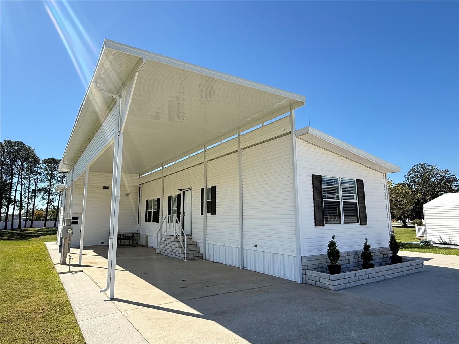 Discover the exceptional Jacobsen Waterfront 1 Bedroom & 1 Bathroom Manufactured RV Port Home, nestled in the sought-after Mount Olive Shores. This property boasts a stunning view of the canal from the inviting Bonus Room, perfect for enjoying Florida's beautiful scenery.
The spacious RV port, measuring 48 feet long and 13.5 feet wide, is designed to accommodate your Class A RV with ample height and space. Additionally, a two-story shed at the rear of the port provides generous storage for all your needs.
Mount Olive Shores is a vibrant and secure gated community, offering unparalleled convenience just minutes from I-4, a variety of shopping outlets and malls, world-class medical facilities, and both Tampa and Orlando International Airports. Plus, the exciting attractions of Central Florida are all within an hour's reach.
This thriving Class A Motor Home community is deed-restricted, ensuring a high standard of living, and requires you to own or lease a Class A motor home your first year of accumulated residency. Don’t miss out on this incredible opportunity to join a welcoming community in a prime location—make it yours today!
