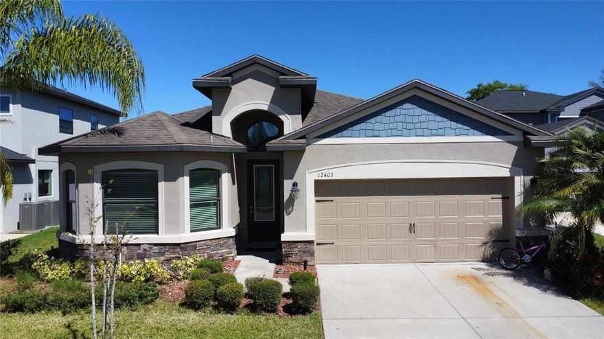 Dont miss your c hance to see this Wonderful modern home, located at Rose Haven, a gated community with NO CDD FEE.  The exterior has fantastic curb appeal, including a bay window, soaring arched front porch, stone accents, and and 8 foot fiberglass door with satin glass insert. You'll fall in love with your first step inside. The foyer is stunning, with upgraded tile that runs throughout the great room and kitchen.  The kitchen features an island bar with dual sinks, and a beautiful quartz countertop that "waterfalls" on both sides. 42 inch upper cabinets with crown molding, GE Energystar appliances, a Moen® Arbor Brushed Nickel single-lever faucet with pull out sprayer, and a closet pantry all included. The kitchen opens to the spacious great room with sliders overlooking the green space and community pool.  The master suite features dual walk-in closets, and the master bath has a walk in shower with full, seamless glass walls and upgraded wall pebble detail in the tile. There are three additional bedrooms, including one with it's own en suite bathroom ideal for an "in-law" suite. Lots of extra lighting in this model, puck can lights, pendant lights, and under cabinet lights in the kitchen. The kitchen cabinets and all bathroom cabinets have been upgraded, and all the bathrooms have granite countertops. You even get a ceiling rainfall shower head in the Master Suite. All bedrooms have waterproof luxury vinyl. The Rose Haven community  has a gated entry, with a beautiful lakeside boardwalk, and community pool and cabana. As mentioned above there is NO CDD FEE, and a low HOA fee of $128 a month. This fee not only covers the pool, cabana, boardwalk, and entry gate, but also covers your trash pick up and basic cable. Conveniently located just a few miles from the Suncoast Parkway for quick commute to Tampa, it is also close to shopping, parks, restaurants, and beaches. So make sure this home is on your list to see, and come  today!! please check the video tour