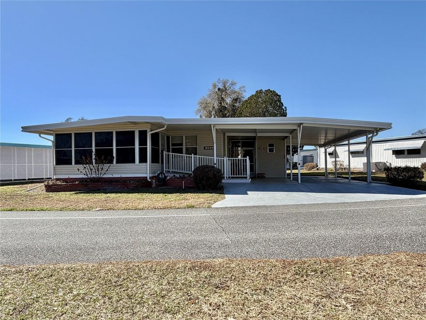 Charming 2-bedroom, 2-bath home in the desirable Palo Verde area offering great curb appeal and excellent potential. Whether you’re looking for a winter retreat, an affordable full-time residence, or an investment opportunity, this home checks the boxes. A spacious 12’ x 38’ carport and 11’ x 49’ concrete slab provide ample parking and outdoor space. A wheelchair-accessible ramp leads into the inviting Florida room, creating a welcoming entry and additional living area. The exterior features low-maintenance vinyl siding, awnings, and a screen-enclosed back porch, perfect for enjoying Florida’s year-round sunshine. Major improvements include a 2008 single-ply roof-over, 3-ton HVAC system (2025), updated main electrical panel (2001), and 30-gallon water heater (1991). Inside, the home offers a comfortable layout with ceiling fans and a mix of laminate, linoleum, carpet, and tile flooring. The dining area features built-in cabinetry, and the fully equipped kitchen includes Formica countertops and generous cabinet space. The spacious primary suite offers a walk-in closet and private bath with walk-in shower. The guest bathroom also provides convenient access to a walk-in shower. Both bedrooms include emergency exit doors for added safety. While the home would benefit from some cosmetic updates and TLC, it presents a fantastic opportunity to customize to your taste and add value. This property is ideal for buyers seeking affordability, flexibility, and potential in a well-established community...........Hawthorne at Leesburg is an active, resident owned, 55+ cooperative, waterfront, gated community, with beautifully landscaped grounds, lakes with illuminated fountains and a relaxing and comfortable gazebo. The affordable monthly maintenance fee of $397 includes water, sewer, lawn mowing, private emergency services and storage space for recreational vehicles, boats, trailers and much more! The beautiful clubhouse is complete with a full-time program coordinator, more than 100 different activities and seating for 550. It has a hospitality lounge, card rooms, craft rooms, billiard room, fitness center, library, fine arts room and many more. There is excellent fishing, outdoor geo-thermally heated pool and two enclosed therapeutic pools. Hawthorne boasts a private marina monitored by an electronic security system with over 120 boat slips and access to the Harris Chain of Lakes and beyond.