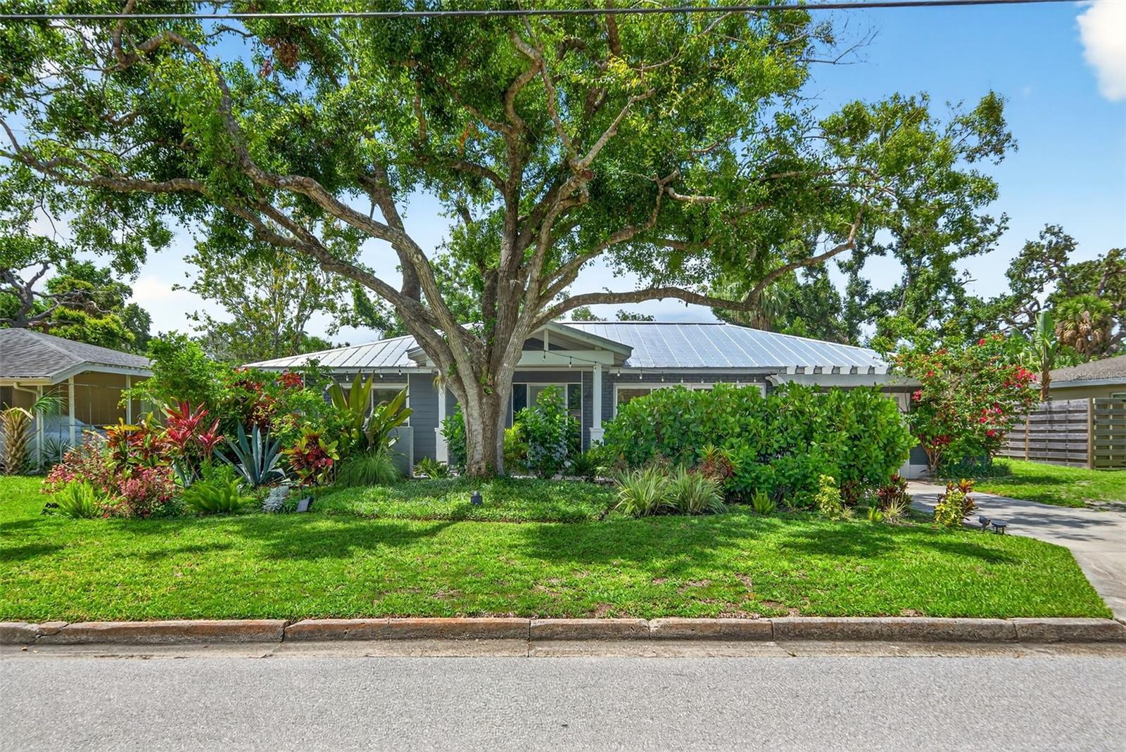 Welcome to 2460 Hillview Street in Sarasota’s charming Arlington Park neighborhood! This beautifully upgraded three-bedroom split-plan home features a 2021 addition including a newer pool and spacious open kitchen, perfect for entertaining. Enjoy serene views of the private backyard oasis featuring the sparkling pool, covered sitting area, and lush mature tropical gardens. Recent 2021 updates include an addition with upgraded finishes throughout, everything new including hurricane-rated windows and doors, and a durable metal roof for peace of mind. Energy-efficient solar panels help keep electric costs extremely low. Located on a premium lot in a friendly neighborhood close to the park, Siesta Key beach and downtown amenities, this home blends modern comfort with inviting Florida charm.