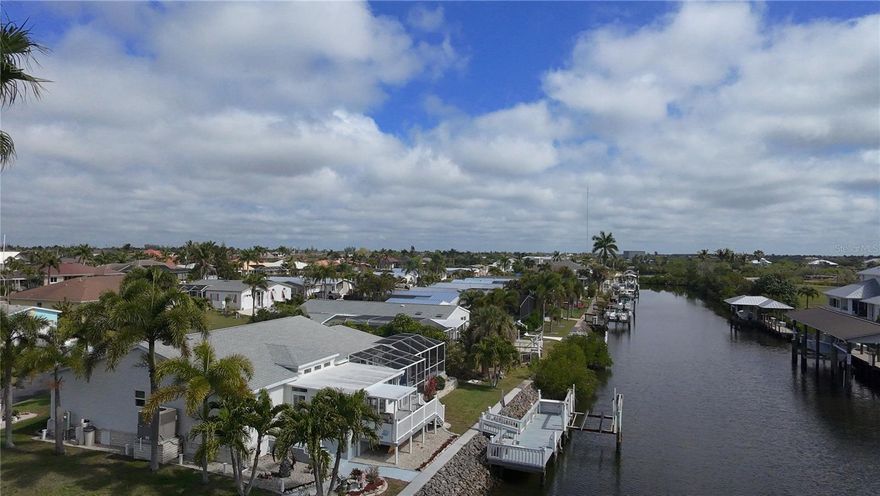 One or more photo(s) has been virtually staged. Nestled in a peaceful Punta Gorda community, this lovely 3-bedroom, 2-bathroom home is designed for comfort and relaxation. The open-concept layout creates a seamless flow from the spacious living room to the well-appointed kitchen, perfect for entertaining or quiet evenings in.

Step outside to your private sanctuary: a large deck and pool area overlooking the water. With direct access to the Gulf and river, your boat is always ready for an excursion. Best of all? You own your land and unit outright, keeping your overhead low and your lifestyle high.