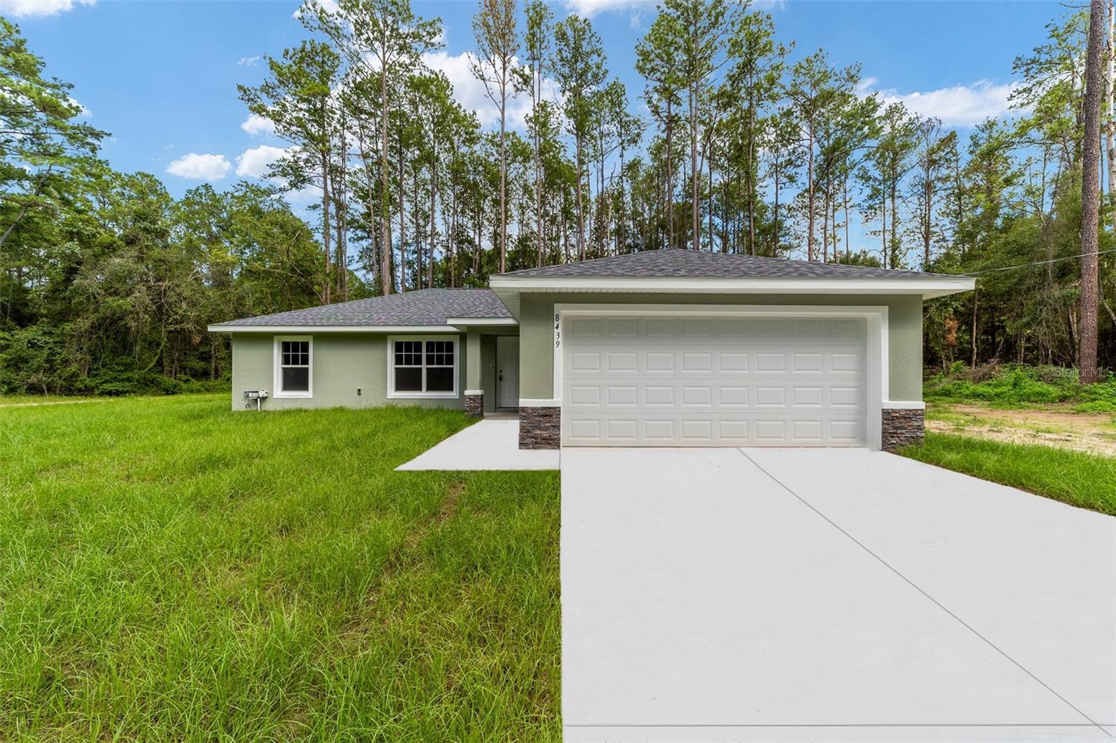 One or more photo(s) has been virtually staged. On .42 ACRES!! Home is complete!! This gorgeous brand-new home located in Citrus Springs is the ideal escape from the hustle and bustle of city life! With an open floor plan, pleasing neutral colors and vinyl plank flooring throughout, this 3-bedroom, 2-bathroom residence has all the charm and comfort any family could desire. Showcasing shaker style cabinets with granite counter tops in the kitchen, a washer/dryer hook up in the inside laundry for added convenience, plus a stainless-steel appliance package, this home is sure to impress. Enjoy your time in the neighborhood while nearby shopping, dining, medical centers and natural springs keep life exciting. Plus, its location near pristine rivers and springs allows for outdoor activities where adventure finds you!