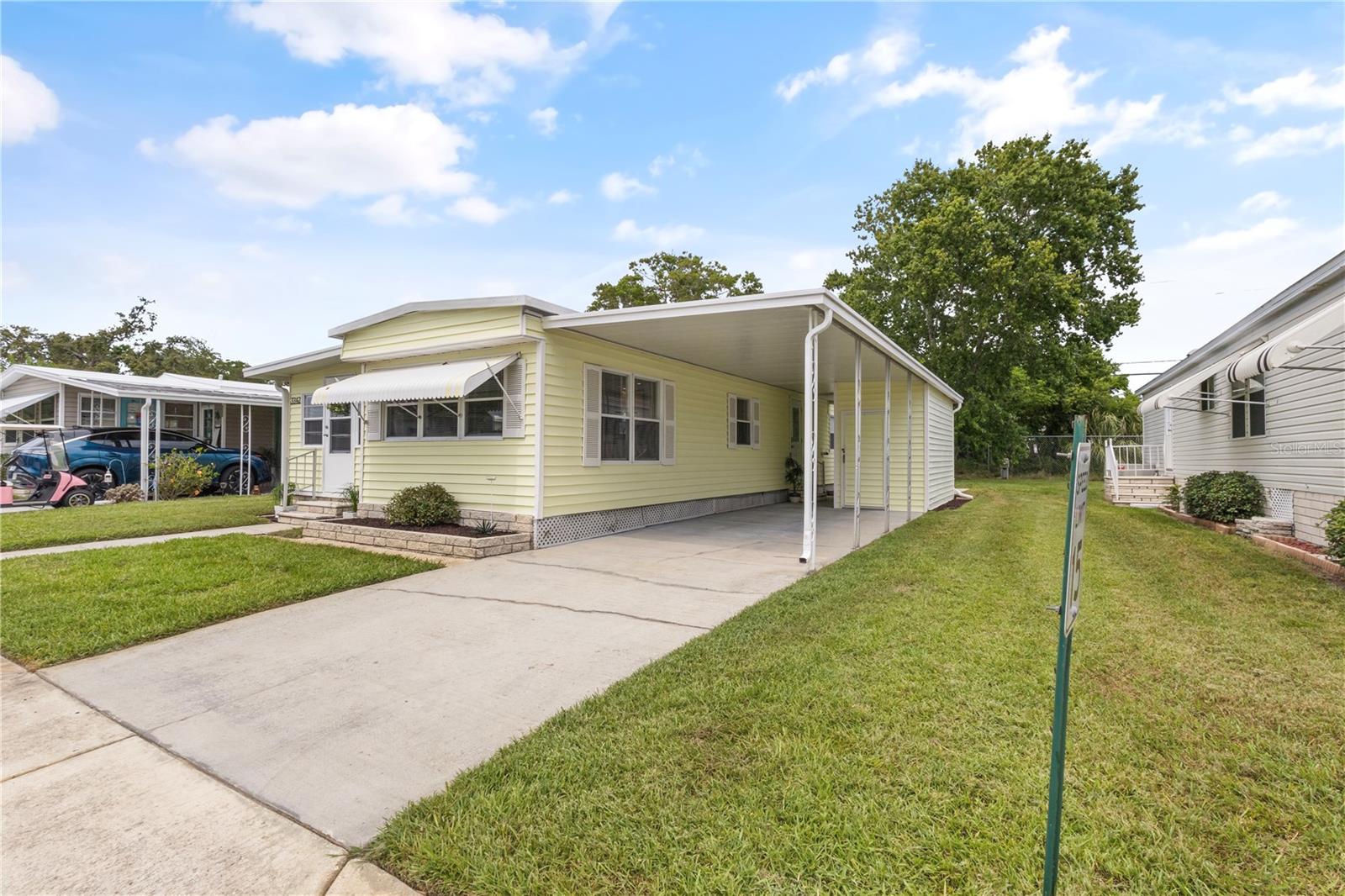 Enjoy Florida Retirement in this beautifully maintained 55 plus community where You Own the Land and don’t have to pay any Lot Rent! This Fully Updated home is being sold Furnished! The sellers will pay 6 months HOA fees with an acceptable offer!
Once inside everything you see and touch is new! Luxury vinyl plank flooring throughout. 4 piece bath completely renovated with double sink vanity, larger shower with floor to ceiling linen pantry. King size primary bedroom with new lighting on dimmers and double closet with organizer. The Luxury Waterproof Vinyl flooring is a nice upgrade that you will enjoy for years to come.
Completely new kitchen with stainless appliances including refrigerator with icemaker, over the range microwave and built-in dishwasher. All new LED lighting with 3 primary rooms on dimmers along with all the lower plugs in sunroom dedicated to a wall switch great for floor and table lamps. Open concept, living room, kitchen and sunroom is a wonderful place to relax and enjoy socializing, reading, or just watching TV! New HVAC system 2022. All new windows, 2025. New Entry Door with Combination Lock. Outside, you’ll find laundry with separate shed both a great size and fully functional. Recently added 14‘ x 11‘ concrete patio is great for entertaining and enjoying private large treed views with all the birds! Make your appointment to see this beautiful home today.