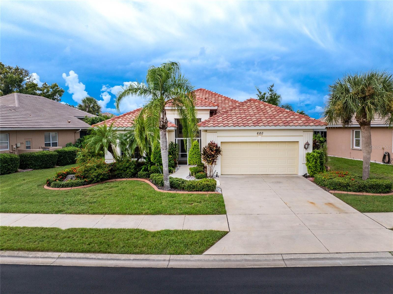 Welcome to Lakes of Jacaranda, one of Venice’s most desirable communities! This beautifully maintained three-bedroom, two-bath home located in the X flood zone features a brand-new barrel tile roof (2024) and offers the perfect opportunity to enjoy the resort-style lifestyle Venice is known for. Outside, you’ll find a well-manicured lawn with mature landscaping and a screened double-door front porch entry leading to leaded glass decorative double front doors with a transom window that invites you to step inside and discover everything this home has to offer. Tile flooring throughout the main living areas and bathrooms will make maintenance a breeze and the stunning architectural details, built in shelving, crown molding, and light fixtures add to the luxury feel of this home. Open the triple sliding doors in the spacious great room to seamlessly extend your living space into the screened lanai and sparkling pool area. The kitchen offers an abundance of white cabinets, quartz countertops, glass tile backsplash, decorative plant shelves, a corner aquarium style window to bring plenty of light inside, and a large breakfast bar. The adjoining nook space will be perfect for your morning breakfast and the large walk-in pantry gives you plenty of storage options. The interior laundry room also includes built-in shelving, cabinets and a laundry sink for added convenience. Double solid French doors open to your private ensuite primary bedroom with sliding doors to the pool area and a spacious walk-in closet. The bathroom feels like a retreat with a custom dual sink vanity, a marble soaking tub, and a separate fully tiled walk-in shower. Two additional bedrooms provide comfortable space, one featuring tile flooring and unique bamboo wallpaper, while the guest bath includes a shower and tub combo accented by a painted mural for a designer touch. Whether you’re enjoying a quiet morning coffee or hosting friends in the evening, the partially screened lanai with pool creates a welcoming outdoor retreat made for Florida living. Highlights include built-in hurricane shutters protecting the covered lanai and sliding glass doors, carpet was recently replaced, and the home is close to all the amenities. Lakes of Jacaranda offers a lifestyle that feels like vacation every day. Residents can enjoy a sparkling pool, a welcoming clubhouse, and courts for both tennis and pickleball, along with year-round neighborhood events that bring friends and neighbors together. The clubhouse is also available to rent for private gatherings, making it easy to celebrate close to home. This location puts you close to everything that makes Venice such a special place to live. From historic downtown, the new Wellen Park to enjoy many events or take in a ball game at the Atlanta Braves Spring Training stadium, and the sandy Gulf beaches to boating, shopping, dining, parks, and miles of bicycle trails, it is all just minutes away. Venice is also known as the Shark’s Tooth Capital of the World. For golf enthusiasts, nearby Jacaranda West Country Club offers championship golf and tennis along with dining, a full bar, and a packed calendar of events to enjoy year-round with paid membership. This home at 680 Lakescene Drive will not last long, contact us today to schedule your private showing.