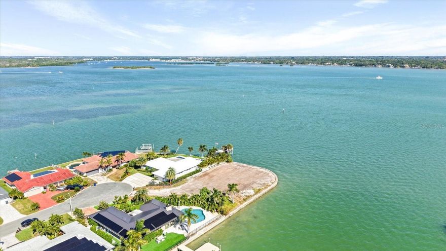 Discover the ultimate canvas for your dream home on this oversized 0.36-acre (15,987 SF) waterfront lot boasting an exceptional 227 feet of waterfront in the highly coveted Isle of Capri neighborhood of Treasure Island. This rare point lot delivers breathtaking, wide-open views of Boca Ciega Bay, along with a 137-foot side canal that’s an impressive 243 feet wide—the perfect setting to design a custom dock or yacht slip. A true paradise for yacht owners and boating enthusiasts alike.
Located on 126th Ave, the furthest north street on Isle of Capri, you’re just around the corner from Johns Pass and only minutes to the Gulf of Mexico by boat. Prefer the beach? Hop on your bike or take a 2-minute drive to Treasure Island’s sugar-white sands. Dining, bars, live music, and iconic local festivals—like Sanding Ovations and the Johns Pass Seafood Festival—are all right at your fingertips.
Imagine relaxing in your backyard watching boats sail by, dolphins play, fishing off your dock, lounging in your pool, or hosting unforgettable gatherings with family and friends. This rare waterfront opportunity invites you to dream big and build even bigger. The perfect setting for a show-stopping coastal estate—don’t let this one slip away.
