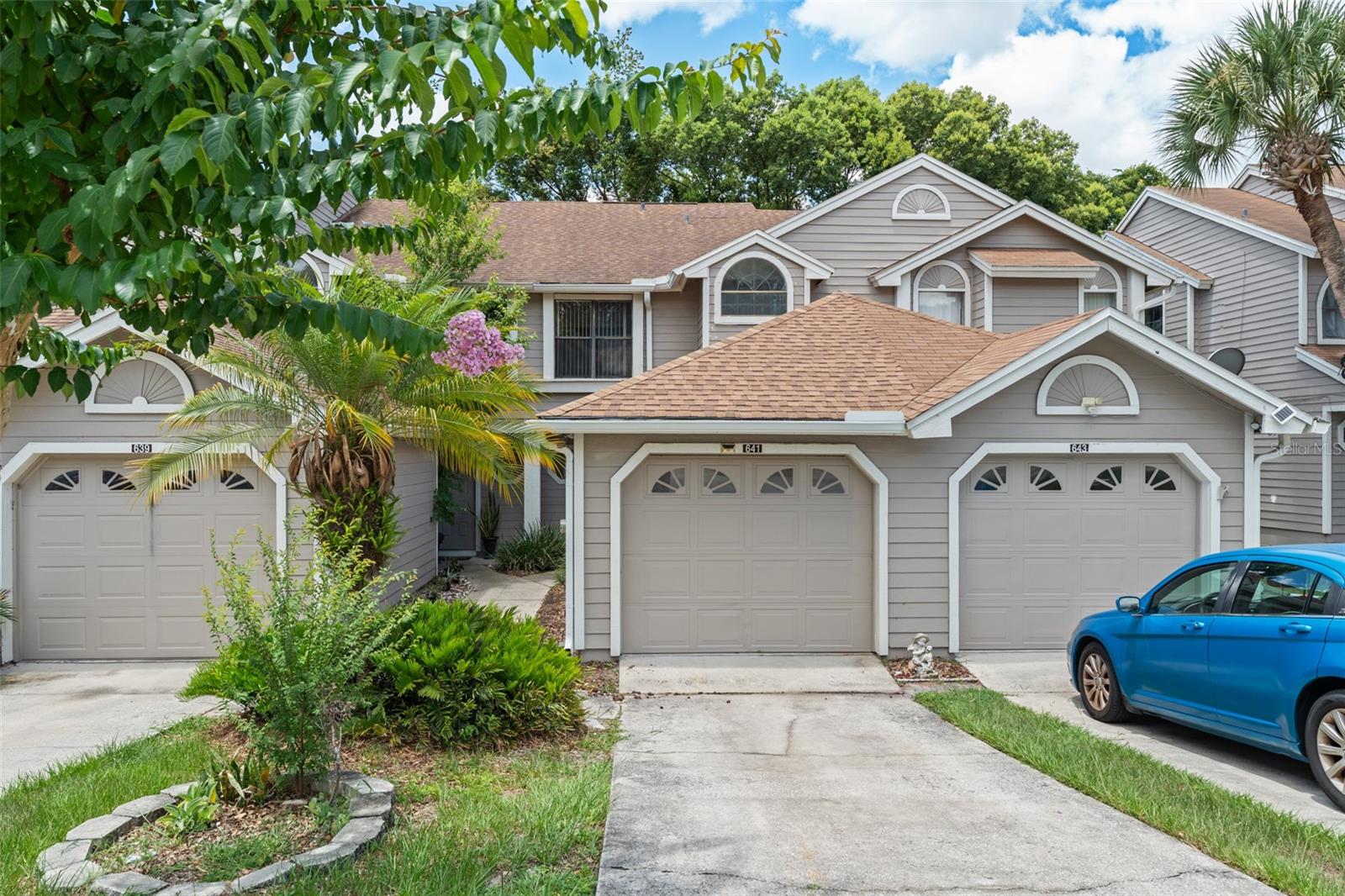 **This property qualifies for a closing cost credit up to $4,000 through the Seller’s preferred lender.** Welcome to 641 Northbridge Drive, a charming and beautifully maintained townhouse nestled in the heart of Altamonte Springs. This 2-bedroom, 2.5-bathroom home with a single-car garage offers the perfect blend of comfort, functionality, and peaceful living. Significant updates throughout the home include a 2020 roof, as well as extensive interior renovations that elevate both style and function. The kitchen has been fully renovated with updated cabinetry, modern appliances, and new tile flooring that continues throughout the main level. Both bathrooms have been refreshed with new vanities, tiled showers, and upgraded flooring, giving the spaces a contemporary feel. Additional improvements include updated light switches and fixtures, as well as smooth ceilings throughout—no more popcorn ceiling! As you step inside, you're immediately welcomed by an open-concept living and dining area, filled with natural light and designed for easy entertaining. To your left, a conveniently located half bathroom offers practicality for guests, while just beyond the entryway, the galley-style kitchen awaits. Featuring neutral-toned cabinetry, a mix of sleek black and stainless steel appliances, and a pass-through serving window, the kitchen effortlessly connects you to the dining space. A large window facing the front walkway bathes the kitchen in sunlight, creating a bright and cheerful atmosphere. A tucked-away laundry closet and access to the garage are thoughtfully placed just beyond the kitchen for added convenience. In the dining area, a stunning floor-to-ceiling mirror adds depth and light, while a cozy nook under the stairs provides bonus storage space. The living room invites you to relax, with sliding glass doors that open to a screened-in porch—perfect for enjoying your morning coffee or unwinding after a long day. The porch overlooks a serene backdrop of mature trees and lush vegetation, offering privacy and a peaceful, natural setting. Just beyond, stairs lead to a paved patio, ideal for grilling or additional outdoor seating. Upstairs, carpet-lined stairs lead you to two generously sized bedrooms. The first bedroom greets you with elegant double doors and includes an en-suite bathroom featuring a modern vanity with gray cabinetry and a white countertop, a floor-to-ceiling tiled shower, and an arched privacy window that fills the space with soft light. A walk-in closet adds to the room’s appeal. Down the hall, the spacious primary suite boasts a soaring vaulted ceiling, dual walk-in closets, and a spa-like en-suite bathroom. Enjoy a double-sink vanity, matching cabinetry, and a beautifully tiled stand-in shower that brings a sense of luxury to your daily routine. This townhouse offers both the comfort of home and the beauty of Florida living in a tranquil, tree-lined community. With major updates already completed, including a newer roof and modernized interiors, this home is move-in ready. Don’t miss the chance to make this warm and welcoming space your own.