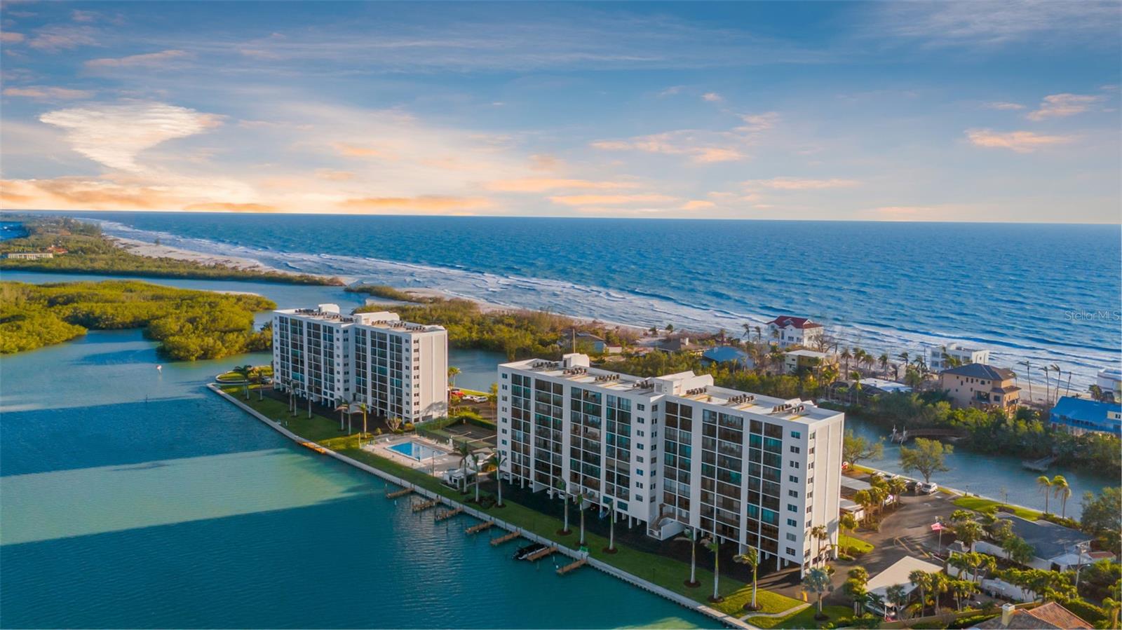 CALLING ALL BOATERS, KAYAKERS & SEA LOVERS – WELCOME TO YOUR WATERFRONT PARADISE! The Pointe on Midnight Pass, Siesta Key, is a 5+ acre gated coastal oasis surrounded by Little Sarasota Bay, the ICW, Blind Pass Lagoon, the Gulf of Mexico, and Jim Neville Marine Preserve. This beautifully updated 2BR/2BA second-floor condo showcases breathtaking water views and invites you to experience nature up close with frequent visits from playful dolphins, gentle manatees, and an array of vibrant seabirds. This tranquil waterfront setting perfectly complements a lifestyle of adventure and relaxation. Enjoy direct water access with kayak launches and boat docks—ideal for paddling, fishing, or cruising. Inside, the gourmet kitchen is a chef’s dream, showcasing granite countertops, custom wood cabinetry, and classic travertine flooring. High-end details continue throughout, with luxury ceiling upgrades that include recessed lighting, crown molding, and refined architectural accents—adding depth and elegance to every room. Built-in custom wood cabinetry and shelving provide both beauty and functionality throughout the condo. Both bedrooms boast stunning water views and direct access to the lanai, where you’ll enjoy breathtaking panoramic vistas—the perfect place to unwind and take in the coastal serenity. Resort-style living awaits at The Pointe, featuring a heated pool, spa, fitness rooms, clubhouse with full kitchen, outdoor grilling and picnic areas, herb garden, lighted tennis and pickleball courts, lush tropical landscaping, butterfly gardens, and your very own private island with BBQ, gazebo, and a front-row seat to observe The Pointe’s resident osprey nest. Seasonal social events, plus walk, bike, or drive to Turtle Beach with ample parking, Crescent Beach, Point of Rocks, and Siesta Key Beach. Free Siesta Breeze Trolley nearby. Easy walk, bike, drive, or trolly to local shopping, dining, entertainment, and recreational water activities. Seize the opportunity to own at this stunning waterfront sanctuary—schedule your private tour today and begin living the coastal lifestyle you've always dreamed of.