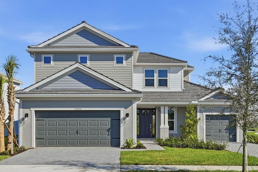 What's Special: Corner Lot | 1st Floor Guest Suite | Covered Extended Lanai | Gourmet Kitchen | Pond View. 
New Construction - Ready Now! Built by Taylor Morrison, America's Most Trusted Homebuilder. Welcome to the Tortola at 35056 Emberview Drive in Hammock at Two Rivers. This stunning new home makes a bold first impression with its soaring two-story foyer. Just off the entry, you’ll find a half bath, laundry room, and a private secondary bedroom with its own en-suite, perfect for guests. At the heart of the home, the open-concept gathering room features oversized sliding glass doors that lead to a sunny lanai, creating the ultimate indoor-outdoor living experience. The spacious gourmet kitchen overlooks this area and includes an elongated island with a stainless steel apron-front sink, stylish pendant lights, a walk-in pantry, and plenty of counter space for meal prep. A cozy dining area completes the space. The main-level primary suite offers a spa-like bath and a generous walk-in closet for your retreat. Upstairs, you’ll find three secondary bedrooms, one with a private en-suite, another full bath, and a large game room for fun and relaxation. Step into Hammock at Two Rivers—a resort-style private social club designed for elevated living. This planned, member-only haven will feature a premier health club, racquet sports, spectacular pool, and more. Savor a meal with neighbors at the planned fine dining restaurant or enjoy a staycation at the poolside bar. Other planned amenities include a playground, lap pool, event lawn, and a slide tower for endless fun. Beyond the community, Zephyrhills offers small-town charm with easy access to Tampa and Orlando. Explore local dining and shopping, cheer on major sporting events, or spend the day at nearby theme parks and beautiful beaches like Sunset Beach and Clearwater Beach. There’s so much to discover! Additional Highlights Include: Gourmet kitchen, pocket slider at great room, extended lanai, bar in great room, 8' interior doors, door at game room, and tray ceiling at great room, primary suite, and foyer. MLS#TB8457119