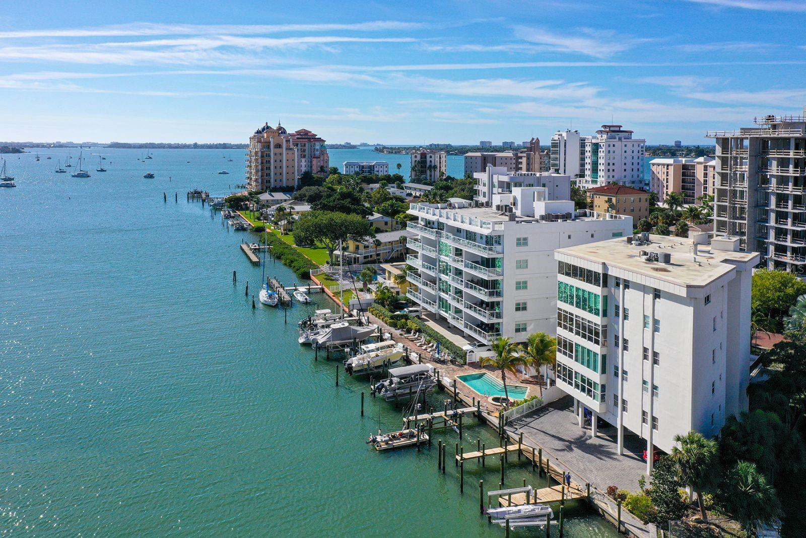 LOCATION, VALUE, AND VIEW — the perfect Bayfront Residence on Golden Gate Point! This beautifully updated 2-bedroom, 2-bath residence offers a rare chance to enjoy Sarasota’s premier downtown waterfront lifestyle. Located in Marina View, a charming, pet-friendly building with only eight residences, this home provides stunning panoramic views of Sarasota Bay, Marina Jack, and the vibrant downtown skyline. Within walking distance to all amenities, with convenient access to the trolley for added ease.
The open-concept layout is filled with natural light and features modern finishes, including a tasteful blend of matched tile and bamboo flooring throughout. The kitchen is a cook’s dream with granite countertops, stainless steel appliances, and a spacious pantry. Both bathrooms have been tastefully renovated, and custom built-in shelving in the closets offers excellent storage.
This residence includes a covered parking space, a private locked storage room perfect for bikes, beach chairs, or fishing gear, secure elevator access, guest parking, and a day dock just outside your window. The building’s flexible rental policy makes it an ideal choice for investors or those seeking flexibility.
Located on Golden Gate Point, you are just steps from Sarasota’s lively arts, shopping, dining, and entertainment scene. Enjoy front-row views of fireworks, the Christmas boat parade, and daily dolphin sightings—all from the comfort of your living room. With easy walking access to art shows, theaters, and Main Street, and just across the street is the Ritz-Carlton Hotel, the Westin Rooftop restaurant and bar, plus quick access to St. Armands Circle and Lido Beach, this quiet, upscale enclave offers a luxurious waterfront lifestyle at an exceptional value.
Do not miss this opportunity to experience Sarasota Bayfront living at its finest—schedule your private showing today!
