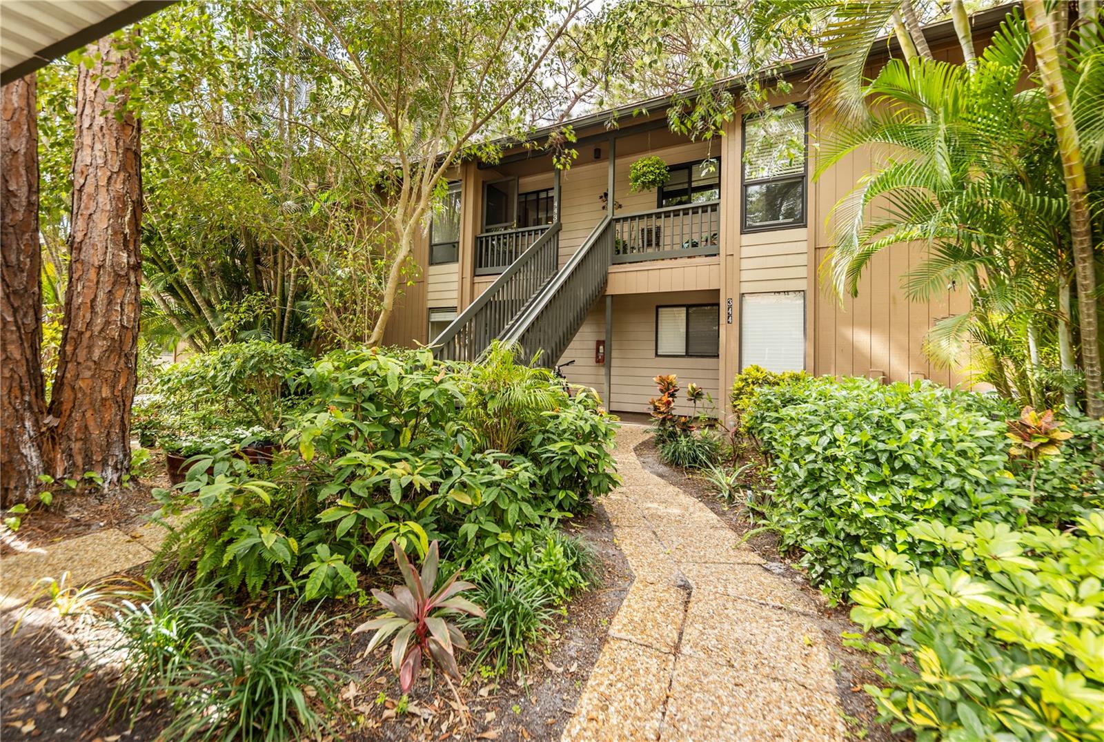 It is easy to enjoy the beauty of coastal waterfront living in Pelican Cove and this 2 bedroom/2 bath condo. The open floor plan with high ceilings and natural light/skylights creates a spacious and inviting atmosphere. The split floor plan includes a master bedroom with updated bathroom, walk-in closet and upstairs attic space for additional storage as well as luxury vinyl flooring throughout. As you drive past the gate, the lush tropical setting, fruit trees, bird watching and manatee sightings in the harbor will offer instant serenity and relaxation. Amenities include art studio, woodworking shop, sculpting garden, 6 pools, yoga, tennis, pickleball, water aerobics, biking, new exercise room and kayak launches to name a few activities. Enjoy an impressive offering of performing arts, annual art show, cinema & culinary club, bridge and fiber arts club.