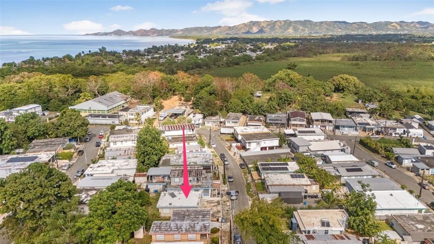 This charming 2 bedroom, one bath house is less than 600 meters from the ocean and nestled in the Quinto Centenario neighborhood that was named after the 500 year anniversary of Columbus's arrival in the Americas. Western Plaza is just a 5 minute drive from this property or approximately 1,300 meters as the crow flies. There you will find everything you could possibly need including restaurants, movie theatre, a gym and grocery store that are both open 24/7. The roof has recently been sealed and the property includes fully fenced in yard with room for 2 cars in front, a solar hot water heater, oven and one AC unit. This is a great opportunity for you first home in Western Puerto Rico or as an investment.