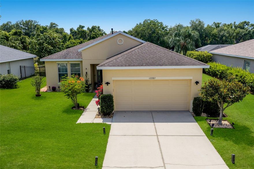 Welcome to 12287 Lavender Loop! With 2,136 sqft of one-level open-concept living space, this waterfront pool home sits tucked inside the 24-hour manned gates of the picturesque community of Greyhawk Landing. As you enter through the front door, you're immediately welcomed with unmatched natural-light throughout, rear western exposure and large sliding doors that open directly onto the screened lanai and heated pool. The eat-in kitchen has been refreshed with white cabinetry, new cabinet and drawer hardware, upgraded stainless-steel appliances, a luxury  induction cooktop, an under-sink water filtration system, and under- and above-cabinet lighting that warms the space at every hour. Additional notable upgrades include a (*Brand-New Shingle Roof being installed May 2026*) a 2023 HVAC, 2022 gas pool heater, whole-home hurricane shutters, updated landscaping and a newly painted front door. This home is also Smart-Home ready! Conveying with the property are Ring Security Cameras and Doorbell, Nest Thermostat, Rachio Smart Irrigation, Smart Garage Opener, Smart Pool Timer, as well as Wired Fiber-Optic internet.
In the front of the home, you'll find a large, versatile den/bonus room, upgraded with a double-door entry that works beautifully as a home office, playroom, or guest space.
The 14x19 sqft. primary suite is its own retreat, boasting beautiful tray ceilings, a private set of sliding glass doors for easy lanai access and a peaceful seating area below  the oversized picture windows. As you enter the primary en-suite, you'll find dual walk-in closets, separate double vanities, a private water closet, and a glass-enclosed walk-in shower with integrated garden soaking tub. 
Two additional bedrooms share a well-appointed full bath at the opposite end of the home, with a convenient half bath off the main living area for guests. Step outside to the screened lanai, already equipped with a gas grill hookup for your future outdoor kitchen dreams!  
The backyard views only get better as the sun goes down and cotton-candy skies arrive nightly over the pond and the private preserve beyond. Life inside the resort-style community of Greyhawk Landing means two clubhouses with heated lagoon-style pools and spas, multiple children's splash zone areas, a spacious fitness center, tennis, pickleball, basketball courts, soccer and baseball fields, a fishing pier, and nearly two miles of walking and biking trails, all behind a guard-gated entry and one of the lowest HOA's in the area!
Greyhawk Landing is located in an A-rated School District, and minutes to the UTC Mall, Waterside at 
Lakewood Ranch, multiple hospitals and medical facilities, I-75, golf courses/sports complexes as well as some of the top Gulf Coast beaches. Schedule your private showing today!