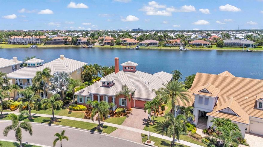 Luxury Waterfront Living in the Heart of Apollo Beach.  Step into refined elegance and coastal sophistication with this stunning, Luxury Key West Style Hannah Bartoletta home. 729 Manns Harbor is located in the Exclusive Mirabay community. A Boaters paradise, with your own PRIVATE DOCK featuring a 20,000 POUND LIFT W/REMOTE awaits to provide Direct Gulf Access! Designed with discerning buyers in mind, this residence combines timeless design with high-end finishes, allowing full natural light overlooking the lagoon!  From the moment you enter, you’re greeted by twelve-foot ceilings and an expansive, open floor plan, enhanced by tray ceilings that add architectural interest and comfortable living.  Split bedroom floorplan, upgraded baseboards, eight-foot doors, and plantation shutters give a seamless blend of style and functionality. The large kitchen features stainless steel appliances, GE Commercial Refrigerator, Gas Stove, Wall oven, granite countertops, 42-inch cabinets with glass, and an oversized breakfast bar—perfect for casual dining or entertaining. The adjacent butler’s pantry is fully equipped with a Miele coffee maker, wine refrigerator, and wet sink. Gather with guests in the great room complete with a fireplace and sliders that opens to a private outdoor kitchen and gas/solar-heated pool. The owner’s suite boasts serene lagoon views, dual walk-in closets, soaking tub and separate shower as well as double vanities. The Guest suite with a private den provides the ultimate comfort and flexibility for multigenerational living, with spacious guest bedroom and bathroom; complete with sliders overlooking the pool and lagoon. Additional features include a full-sized laundry room with cabinetry and a deep utility sink, surround sound system, Newly Upgraded High Efficiency Carrier A/C units, security system, and hurricane impact double-paned windows and doors for energy efficiency and peace of mind. Enjoy the lifestyle in Mirabay, a premier coastal community offering residents exclusive access to a clubhouse, resort-style pools with waterslide, fitness center, and complimentary kayaks for exploring the scenic waterways. This home was HIGH AND DRY after both hurricanes in 2024!  3-car Tandem Garage.  Sit back and enjoy Florida Waterfront Living in this meticulously kept home!