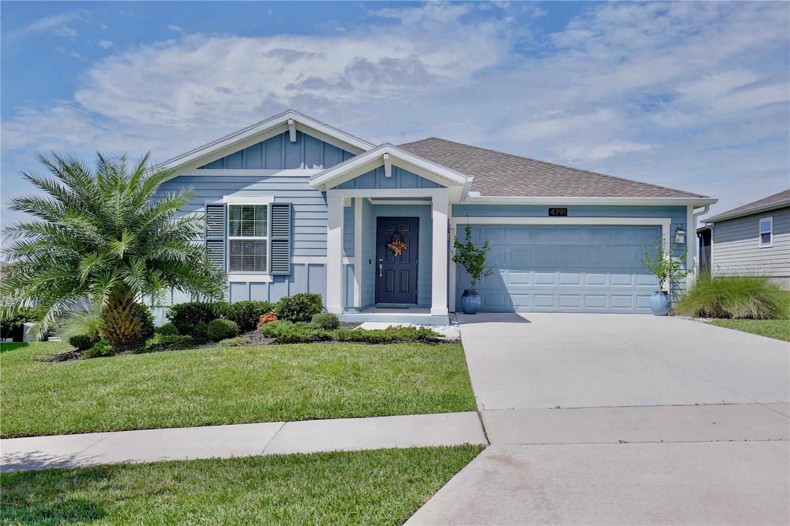 Discover the epitome of comfort and style in this stunning three bedroom, two bathroom house nestled within the serene Stoneybrook Hills gated community. Boasting eye catching curb appeal and meticulous landscaping, this home greets you with a warm embrace. Step inside to an open floor plan, where tall vaulted ceilings and neutral colors create an airy and spacious ambiance. The wood style floors complement the abundant natural light that pours in. The heart of this residence is the chef inspired kitchen, equipped with gleaming stainless steel appliances, a center island with bar top seating under pendant lights, ample pantry storage, granite countertops, and mocha shaker cabinets. The adjacent dining room offers the perfect transition to the outdoors with sliding glass doors that lead to a patio, an ideal setting for social gatherings, barbecues, or peaceful evenings. Relax in the spacious living room, which conveys a television and an electric fireplace. A large primary suite awaits, complete with a walk in closet and an en suite bath featuring dual sinks and a sleek glass door shower. Two additional bright and welcoming guest bedrooms along with a guest bath, featuring a tub/shower combo, provide comfort for family or visitors. The practical laundry room includes a washer and dryer and provides direct access to the generous two car garage. Step outside to a backyard haven, where a patio adorned with fire columns offers a cozy retreat on chilly nights. Residents of Stoneybrook Hills enjoy a plethora of amenities including a community swimming pool, splash pad, basketball court, pickleball courts, and a playground. Conveniently located just a stone's throw from a Publix plaza and with quick access to highways 429 and 441, this home is also a mere four miles from the enchanting downtown area of Mount Dora, known for its quaint boutiques, restaurants, and wine walks. Immerse yourself in the 3D tour and seize the opportunity to schedule a showing today for a lifestyle enveloped in comfort, convenience, and charm!