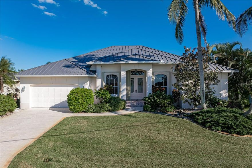 SAILBOAT ACCESS HOME W/NEW METAL ROOF, 84FT OF WATERFRONT & 60FT CONCRETE DOCK! Located in Punta Gorda Isles, this spacious 3 bed/2 bath, single-family home w/den offers over 2,500 sq ft under air and is brimming with potential. Designed with an open layout, the home features a formal living room, formal dining area, a separate family room, and a generously sized kitchen. The original finishes, while well-maintained, present an ideal opportunity for modern updates. Solid construction and great bones throughout with a brand-new metal roof (2024), new pool cage (2023), and hurricane protection already in place. The large kitchen includes two closet pantries, a breakfast bar, and a built-in recipe desk. The split bedroom design provides privacy for owners and guests alike, while a den just off the foyer adds flexibility for an office, hobby room, or overflow space. Zero-corner sliding glass doors in the family room and disappearing sliders in the living room that open fully to the lanai highlight the home’s potential for seamless indoor-outdoor living. Architectural features include soaring ceilings w/tray elements, arched doorways & decorative plant shelves. The master suite features a large master bath and oversized walk-in closet. The laundry room is tucked off the master suite - no more dragging laundry across the house! The guest bedrooms share a guest bath w/step-in tub. Step outside where you'll discover the spacious, screened lanai. It offers a covered seating area and large sun deck that surrounds the in-ground pool. New pool pump in 2025. Canal views await from almost every vantage point. The 60-ft concrete dock w/20k lbs boat lift is steps from the backdoor. Water & electric hook-ups are available dockside. Dock is located along the 84-ft seawall. Seawall is maintained by the city of Punta Gorda ensuring one less thing to worry about. Sailboat access to Charlotte Harbor is available via Buckley’s Pass or Ponce Inlet. Set off on your latest adventure from your own backyard! Other amenities include an attached two-car garage, in-wall speaker system and tankless hot water heater. Home is surrounded by lush, well-maintained tropical landscaping. This is a fantastic opportunity to update a custom-built home by Fero Construction to your taste while claiming your spot in one of Punta Gorda’s premier boating communities. Located near St. Andrews South Golf Club, and just minutes from downtown Punta Gorda, Fishermen’s Village, dining, parks, and more. No HOA, but residents may join the Punta Gorda Isles Civic Association which hosts a variety of clubs - name your hobby and there's probably a club or group that's waiting for you.