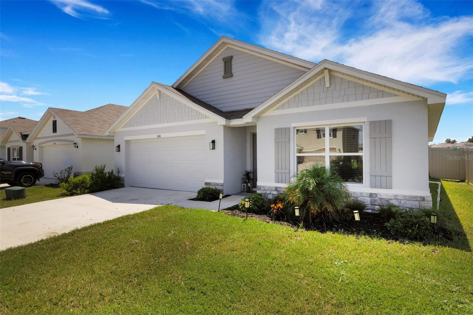 Welcome to 3214 Silver Date Dr—a beautifully designed 4-bedroom, 2-bath home in the sought-after Berry Bay community of Wimauma. Built in 2024 and move-in ready today, this premium lakefront property offers all the advantages of new construction without the wait. Inside, the open floor-plan flows seamlessly between the living, dining, and kitchen areas, creating the perfect space for entertaining or everyday living. The gourmet kitchen features granite countertops, stainless steel appliances, and extended tile flooring for both style and durability. A built-in Smart Home system lets you control comfort, security, and efficiency right from your phone. Set on a premium lot with a fully fenced backyard overlooking the lake, this home offers privacy and a peaceful view. Berry Bay residents enjoy resort-style amenities including a clubhouse, playground, and pool—perfect for a vibrant, active lifestyle. Why wait months for a new build when this one is ready now? Move into your dream home today and start enjoying the best of Berry Bay living.