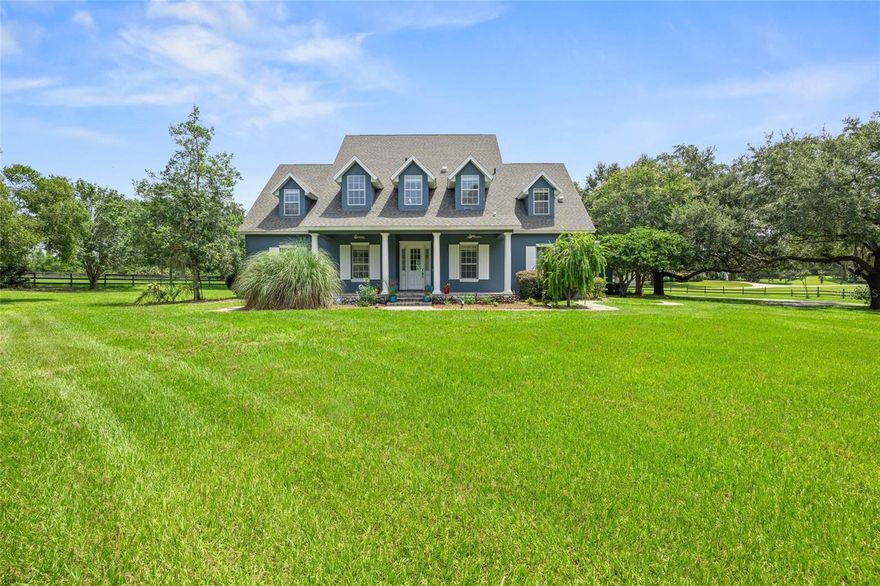 Welcome to the quiet and peaceful equestrian subdivision of Post Horn, where this property offers that rare combination of a manageable-sized horse farm, together with a spacious and well maintained home. This 5 BR/4.5 BA classic gabled home features a front porch with sweeping vistas. As you step inside you're greeted with wood-like tile flooring throughout, an expansive, airy flow with beautifully beamed ceilings, a stunning gas, double-sided stone fireplace and 3 sets of french doors to the fabulous pool area. The outdoor space is perfect for entertaining with it's covered patio, outdoor summer kitchen, outdoor shower and freshly sealed pavers that surround the 36'x18' pool. The kitchen has an updated warm and rustic feel with top of the line appliances, 2 copper sinks and island with seating. The main floor has the large primary with an area perfect for your home gym, office or seating area. The primary bathroom has two walk-in closets, a large walk-in shower, dual vanities and gorgeous claw foot soaking tub, as well as direct pool access. The second floor is breathtaking in it's size alone with a loft area to be used as a playroom or another entertainment area. With 4 large bedrooms, two with ensuite bathrooms and balconies, there is always room for guests. The property is completely fenced so your horses can appreciate the lush grass of 3 large paddocks that encompass the 3 stall center aisle block-built barn with tackroom and washrack. Conveniently located in the gated horse community of Post Horn and in the center of Marion County's horse country, sitting on 5+acres, with frontage on 475, it's an easy commute to town, hospitals, schools, the Florida Greenway and the Florida Horse Park. With a new roof in 2021 and 2 new HVACs in 2023, this gorgeous property is ready for you!