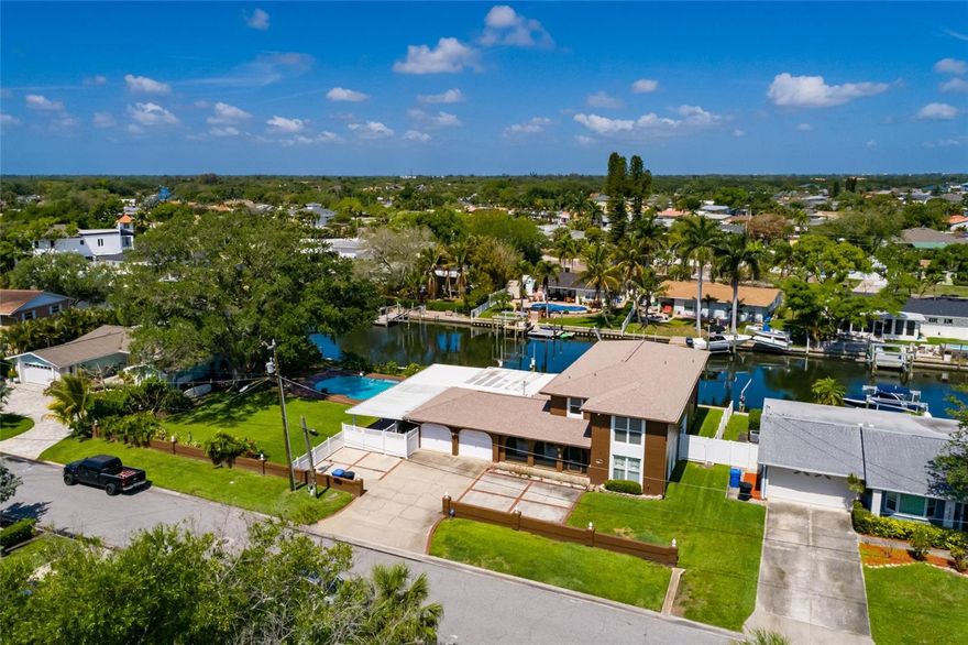 Welcome to your dream waterfront retreat in St. Petersburg! This spacious 5-bedroom, 3-bathroom two-story home offers 3,298 square feet of comfortable living space, perfectly situated on a rare double lot totaling 0.35 acres (15,381 sq ft) along a beautiful canal.

Enjoy the best of Florida living with an oversized pool, ideal for entertaining or relaxing in your private backyard oasis. The kitchen features granite countertops, lots of counter space and a great view of the canal, providing both style and functionality for everyday living and hosting. A new roof was installed in 2025 also. 

With generous living areas and a flexible floor plan, this home offers plenty of space for families, guests, or a home office setup. The expansive lot provides added privacy and room to expand, garden, or simply enjoy the outdoors.

Conveniently located just 10 minutes from downtown St. Petersburg, you’ll have easy access to dining, shopping, and vibrant city life, while still being close to the area’s beautiful beaches and Fort De Soto.

Don’t miss this unique opportunity to own a waterfront property with space, updates, and an unbeatable location!