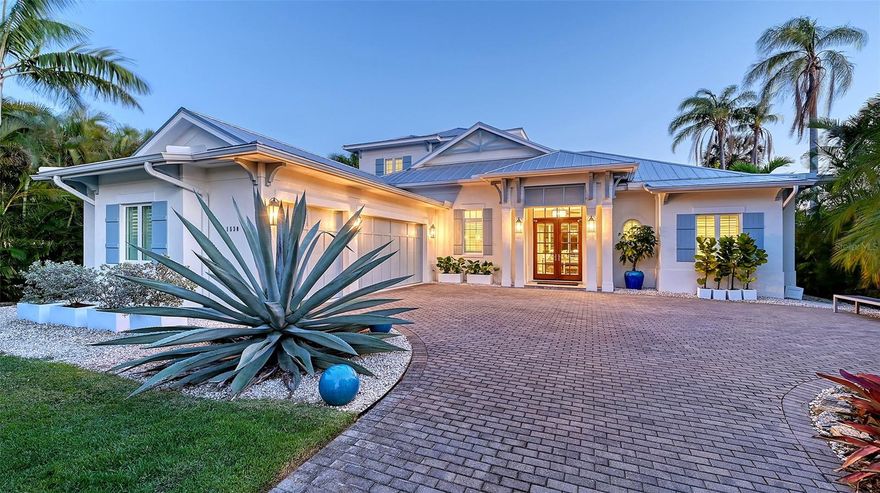 One or more photo(s) has been virtually staged. Welcome to The Islamorada—a 2017-built coastal contemporary residence by Heritage Builders, ideally located in the highly sought-after Oyster Bay neighborhood of Sarasota. Blending expert craftsmanship with elegant design, this exceptional home offers the rare combination of luxury, privacy, and convenience—just moments from The Field Club, Siesta Key Beach, and the cultural heart of downtown.
Step inside to soaring vaulted ceilings, expansive windows, and a warm, transitional aesthetic that exudes both comfort and sophistication. The thoughtfully designed open floor plan flows effortlessly from the spacious great room to the dining area and gourmet kitchen—perfect for entertaining or relaxing in style.
The chef’s kitchen is a showpiece, outfitted with JennAir Pro Series stainless steel appliances, full-height designer backsplash, custom cabinetry, and a walk-in pantry.
The main-level primary suite is a private retreat, featuring dual walk-in closets and a spa-like bath with separate vanities, a freestanding soaking tub, and a glass-enclosed shower with dual shower heads, a bench seat, and designer tile details. Also on the first floor are a guest bedroom and a versatile office or den. Upstairs, a generous bonus room and two additional bedrooms provide ideal accommodations for family or guests.
Step outside and enjoy the best of Florida living. The screened lanai offers travertine pavers, a custom pool with sun shelf, gas-heated spa, and a full outdoor kitchen with built-in grill and exterior-grade cabinetry. Hurricane-rated electric roll-down screens, a whole house generator, and a 500-gallon propane tank offer year-round peace of mind and comfort.
Every detail has been thoughtfully curated with high-end finishes throughout: wide-plank hardwood floors, porcelain tile, plush carpeting, 8’ solid-core interior doors, impact-rated Low-E insulated windows, custom wood cabinetry, and a stunning mix of quartz and granite countertops. The oversized three-car garage is complete with insulated doors and epoxy flooring.
Located West of the Trail in one of Sarasota’s most desirable communities, this home offers unmatched quality, comfort, and coastal charm.