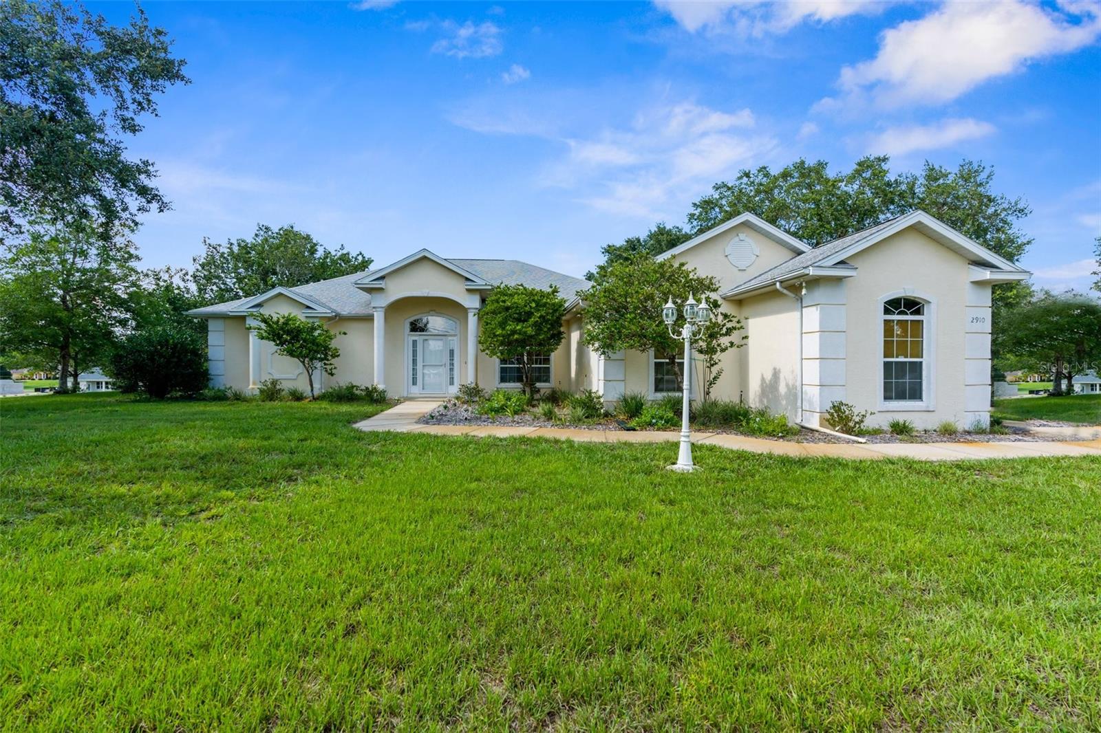 One or more photo(s) has been virtually staged. Welcome to this well-maintained 3-bedroom, 2-bathroom home situated on a full acre in the desirable Citrus Hills community. With over 2,000 square feet of living space, this custom-built, one-owner home features a spacious layout and a prime corner lot surrounded by mature oaks and professionally landscaped grounds.
Inside, vaulted ceilings and large windows bring in natural light and create a bright, open atmosphere. The main living area flows seamlessly into a formal dining space, and sliding glass doors lead to a screened, covered lanai perfect for outdoor enjoyment. The kitchen offers generous counter space, matching appliances, and a casual dining area. A new refrigerator was installed in 2025.
Thoughtfully designed for accessibility and comfort, the home includes extra-wide 36-inch doorways and grab bars for added support. The split-bedroom layout ensures privacy. The primary suite features two walk-in closets and a large bathroom with walk-in shower, bidet, and ample linen storage. On the opposite side of the home, two additional bedrooms and a full guest bath provide flexible space for family, visitors, or a home office.
Step outside to a tranquil lanai overlooking a peaceful backyard retreat. When in bloom, the vibrant gardens and flowering landscape create a setting your guests won’t forget. The extended driveway offers plenty of parking for family and friends. Major upgrades include a 2014 roof, 2019 HVAC system, 2014 water heater, a new septic system in 2022, full irrigation, and city water service.
Located in a quiet neighborhood with low HOA fees. Membership to Citrus Hills Country Club is available but not required. Close to Crystal River, the Gulf of Mexico, and a range of local dining and shopping options, this home blends comfort, function, and location.
Schedule your private tour today and experience all this property has to offer. All information in the MLS is intended to be accurate; buyer and buyer's agent to verify. Appt. required.