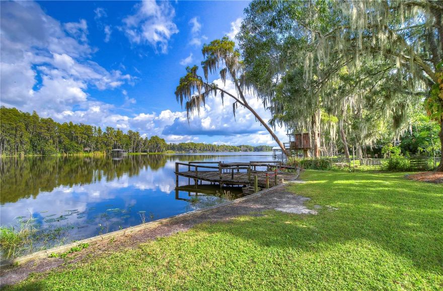 Charming lakefront home on 122 acre King Lake.  Enjoy gorgeous sunsets & tranquil lakefront views w/ 90 ft lake frontage MOL  featuring a private boat ramp, dock & seawall.  This quaint 2 bedroom/ 1 bath home w/ Living Room, Florida Room & Eat-In Kitchen has new carpeting,  7 yr old roof  & 6 yr old AC. The spacious Breezeway opens to the brick Patio with a panoramic lakefront view.  The one car garage includes a large workshop w/ built in cabinetry. An Old Republic Home Warranty will be included with the sale for added peace of mind. So bring your fishing poles & your boat ...the lake is waiting for you!!