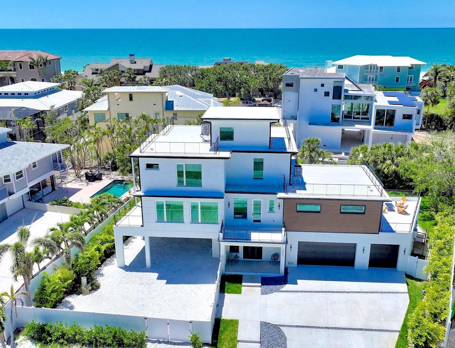 Host your family, friends, or dream vacations at this New Construction Luxury Beach House with Ocean Views on Siesta Key. Experience the best of coastal living in this brand-new 4 bed, 4.5 bath luxury home with walking access to Turtle Beach. With 3,676 SF of thoughtfully designed space, this home offers breathtaking 360-degree ocean views, multiple outdoor patios and terraces, and seamless indoor-outdoor flow. Feel the sea breeze in the spacious backyard, including a pool, hot tub, and outdoor kitchen. The expansive living space hosts plenty of flexible area for an office, gym, game room, or media room.
Enjoy light-toned engineered hardwood floors, a chef’s kitchen with top-tier appliances, and spacious en-suite bedrooms, including a stunning primary suite with a private terrace and spa-like bath.
Additional features include a 3-car garage, and 6 covered carport spaces for recreational utility vehicles such as, jet skis, golf carts, or a boat, with easy gate access. Enjoy an elevator included layout, and high-end finishes throughout—all just minutes from Siesta Village’s shops and dining.
Whether for full-time living or a coastal getaway, this is Siesta Key luxury at its finest.