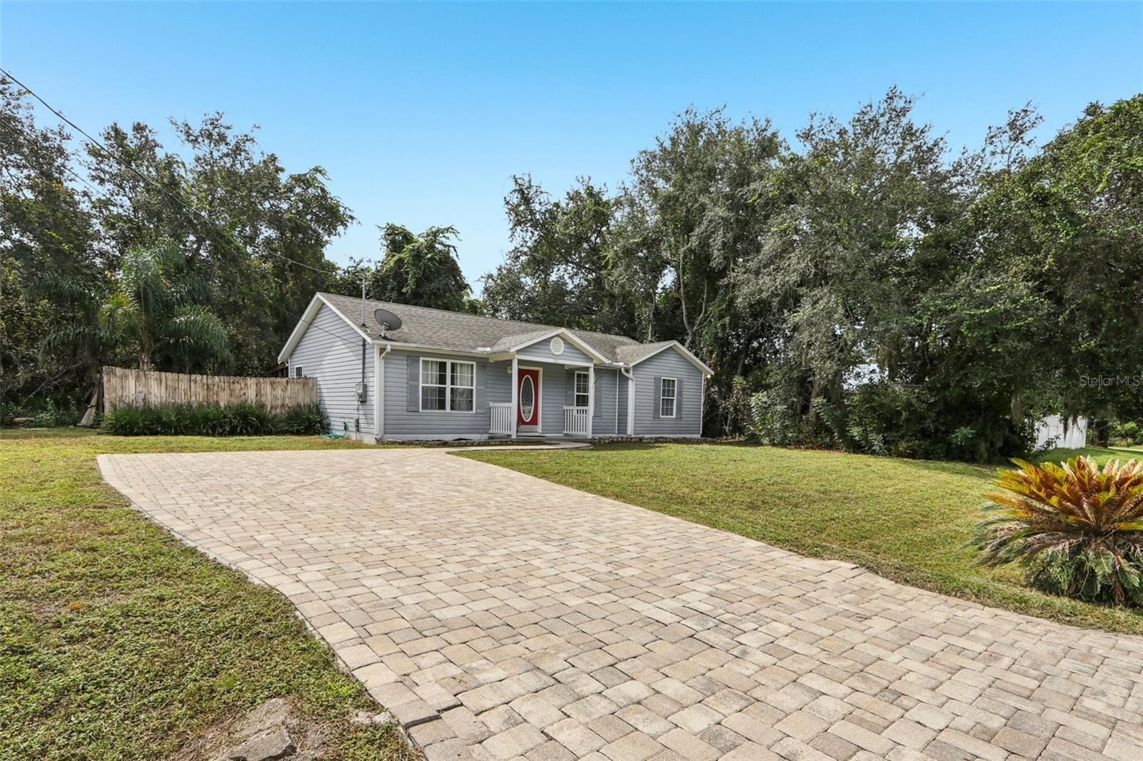 Located in the quiet, country-style community of Venetian Isles, this unique 3-bedroom, 2-bathroom single-family home offers something truly special, not only the home itself, but also the additional lot directly behind it, for a combined total of .36 acres. Whether you're looking to build a second home, expand the existing property, or simply enjoy the added space and privacy, this rare opportunity provides flexibility that’s hard to find. With no HOA and no CDD, you’ll have the freedom to live how you want, bring your RV, your boat, or start that backyard project you’ve always dreamed of. Tucked just off US-1, the location offers quick, easy access to Jacksonville, the airport, downtown St Augustine and the area’s beautiful beaches. The home has been thoughtfully maintained with recent power washing, paved driveway giving it great curb appeal and plenty of parking!. Inside, you'll find a functional open floor plan layout with tile and vinyl flooring throughout, no carpet anywhere! Newer stainless steel appliances and a cozy gas fireplace in the living room for those cool NE Florida winter nights. The stackable washer and dryer are included, making it move-in ready from day one. Plenty of storage space with a combo laundry room split with pantry! Enjoy mornings on the partially screened-in covered back porch! Take advantage of two sheds on the property for extra storage or workspace. Venetian Isles backs up to the Intracoastal Waterway and Stokes Landing Park, offering a peaceful natural setting that complements the quiet, laid-back lifestyle this home provides. If you’re looking for space, privacy, and a little more freedom, all within diving minutes of everything Northeast Florida has to offer, this property is a must-see. Short Term rentals allowed!