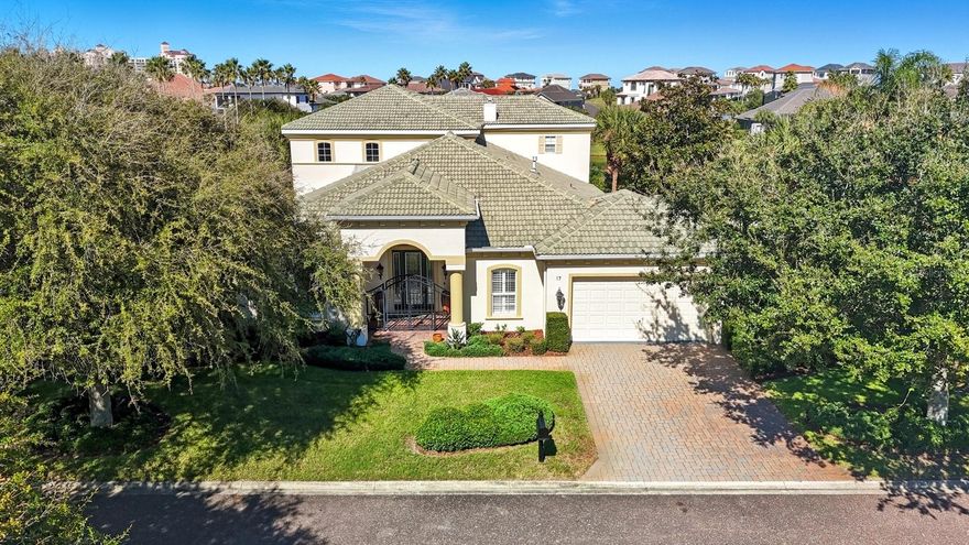 Traditional, understated elegance in this beautiful LAKEFRONT HOME in the Oceanfront Resort Golf Community of Ocean Hammock, in Palm Coast. On a culdesac street with approx. 1/4 acre facing a community lake, this property is a MUST SEE! Custom built in 2006, and in IMMACULATE condition, this home has some unique features that give it that "WOW" factor! A neutral palette of complimentary wall colors, upscale lighting & window treatments, 8’ raised panel doors, and gorgeous cherry hardwood floors set the stage for a tasteful, timeless design throughout the home. Upon entry there’s a clear sightline to the back of the house, lending a sneak peek at what’s to come! Behind the French Doors to the left is one of the bedrooms (with its own bath), utilized as a home office. The formal living & dining space is dressed to impress w/ soaring ceilings, stately columns, crown moldings, beautiful trim work and an amazing, coffered ceiling! The fireplace creates a warm & inviting atmosphere, and the adjacent dining room can accommodate a large gathering when entertaining guests. NEXT, your eyes are immediately drawn to the stairway with iron spindles & wood rails leading up to the LOFT LIBRARY. But wait…the KITCHEN is the REAL SHOW STOPPER! Dark wood cabinetry spans the entire side wall, and small sections of block glass set in the backsplash allow the sunlight to sparkle on the granite counters. The upscale stainless appliances, range hood and GAS grill-top stove make you stop & take notice, while the wall ovens and large center island just might entice you to stay home & cook! Adding to the appeal is a built-in desk area, large breakfast nook w/ mitred glass picture window, and ANOTHER center island BAR with sink & icemaker! NOT TO BE OVERLOOKED is the oversized double door refrigerator, walk-in pantry, AND a fabulous Butler’s Pantry with the same tasteful granite & wood cabinetry w/ glass doors to display your finest dinnerware! The family room has its own touch of WOW, showcasing a double set of sliding glass doors that open from the corner creating a large opening to the lanai, presenting an unobstructed water view and seamlessly bringing the outdoors in! THE LANAI is a definite contender for THE MOST FABULOUS FEATURE!! Covering the full width of the house & wrapping around the side, this space offers SPECTACULAR WATER VIEWS, and is a great place to relax & unwind or enjoy the company of family & friends. The primary en-suite is on the main level and is quite spacious w/ seating area, access to the lanai, and an amazing walk-in closet that’s custom configured for organizational storage. The bath is well-appointed with two large separate vanities, a luxurious garden tub, oversized shower and private water closet. Another custom design feature is the unique & convenient connection from the primary en-suite directly into the laundry room (with a separate entrance from the house). Every bedroom is an En-Suite, and there's a powder room on the main floor as well. The upstairs bedrooms are separated by a gathering space in the loft, and a covered screened-in balcony with more beautiful views! The oversized garage is approx 30 x 18 and has additional storage space, with access to the attic as well. *The freezer and wine frig under the stairs, the firepit on the lanai, and the invisible fence surrounding the property will all convey with purchase. *Water Heater, Fireplaces, Cooktop & Outdoor Grill work on Propane. HVAC=2017 (2 units, 4 zones).