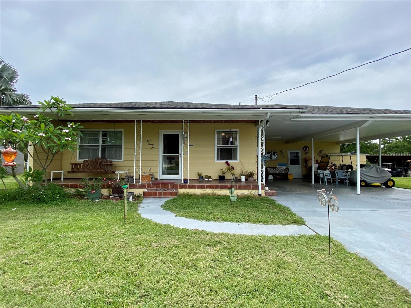Welcome to your cozy little paradise that has two bedrooms, two baths and is located on a wide canal that leads out to Lake Hatchineha on the famous Kissimmee river chain of lakes. As you enter the home, the kitchen has an abundant amount of custom made cabinetry. The living room features French doors that open out into the Florida room that overlooks the beautiful waterfront property. The master bedroom has a walk in closet and full bath, it also has French doors that leads out to your very own hot tub. The two car carport is very spacious with a breezeway and two storage rooms. The boat dock area features four slips, and one lift and is large enough to entertain all of your friends and family. Feel free to bring your golf cart and visit with your neighbors in the golf cart friendly neighborhood. Don’t forget your boat, as you are on the intracoastal waterway that leads to the gulf or the Atlantic. Start living the lake life now, you will be glad you did.