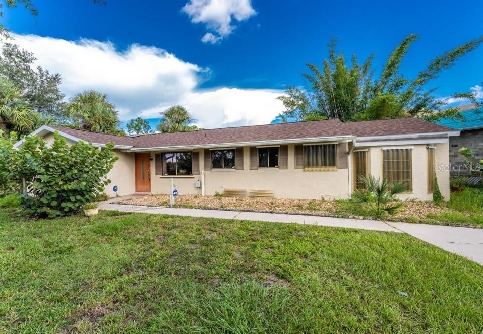 This 3-bedroom, 2-bath concrete block home sits on an expansive 0.30-acre corner lot in a desirable Port Charlotte neighborhood just minutes from canal access. With two oversized driveways, there’s ample space to accommodate RVs, boats, or multiple vehicles, truley a rare find in this price range. The floor plan includes a spacious kitchen, a covered Florida room extending from the living area, and a dedicated office that could easily convert into a fourth bedroom. Recent improvements include a new roof in 2023 and a 2018 HVAC system, providing a solid foundation for future updates. The home features an in-ground spa on a screened deck and a two-car garage that shows visible signs of a prior flood event. Due to some needed updates and conditions, this property may not qualify for FHA or VA financing and is best suited for cash or conventional buyers. This is a prime opportunity for those seeking long-term value in a well-located, high-potential home. Don’t miss this great opportunity —schedule your private tour today!