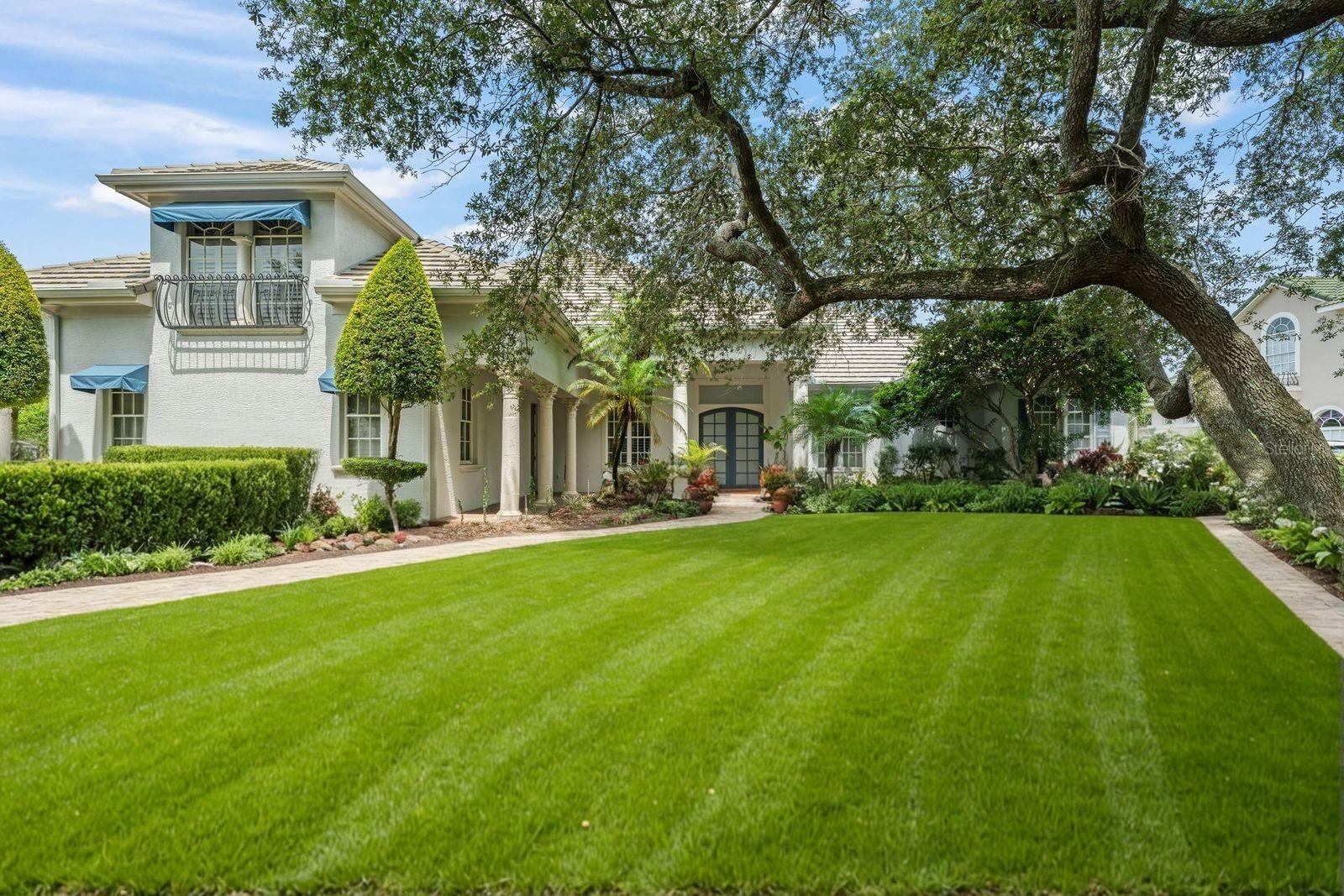 Luxury, Location and Lifestyle! Come experience this fully renovated, resort-like property nestled in a highly coveted, gated community in Dr. Phillips. This exquisite 5-bedroom, 5-bathroom residence has been professionally designed and meticulously curated living space on very private lot, that will dazzle even the most discerning homeowner.
Step into an ambiance of effortless sophistication as open concept living areas unfold seamlessly, providing an ideal canvas for both intimate gatherings and grand entertaining. Gleaming brushed white oak hardwood floors extend throughout the contemporary design, reflecting the abundant natural light that streams in. Upon entering the grand, double-doored foyer, soaring ceilings immediately elevate your spirits, creating an impressive sense of arrival. The expansive split floor plan, encompassing both a formal living room and a family room, offers ample space for a growing family.
The gourmet kitchen, is a culinary dream and will delight the Chef in your family. Striking countertops, crafted from rare natural Oceania quartz, introduce an unparalleled sophistication, serving as the kitchen's focal point. Top-of-the-line LG appliances, a massive island comfortably seating six, a charming eat-in breakfast nook, and 42-inch custom wood cabinetry. A separate wet bar further enhances its entertaining prowess. Stunning backsplash of Dolomite Carrara marble with intricate gold inlay establishes a tone of timeless elegance that permeates the home's aesthetic.
The oversized primary suite offers a private sanctuary, featuring elegant French doors, custom-designed 'his-and-hers' closets, and a dazzling en suite that is a must-see. A breathtaking expanse of floor-to-ceiling blue onyx, high-gloss marble commands attention upon entering the primary bathroom. This luxurious retreat boasts a marble double vanity with sophisticated oak cabinetry, custom lighting, a deep freestanding tub, and a double-occupancy, spa-like glass shower.
A thoughtfully appointed junior suite on the second floor offers a renovated bathroom, plush memory foam carpeting, a dedicated sitting room, and a spacious closet. Every bedroom is complete with en suite bathroom, each showcasing stunning marble finishes and high-end installations. Beyond the stunning interior, this custom-built home extends its allure outdoors with a generous in-ground pool complemented by a private, low-maintenance lanai. Prepare to be captivated by the brick-paved courtyard. This secluded setting forms a serene oasis, perfect for effortless indoor-outdoor living, offering ample space even for activities like pickleball or half-court basketball. Elegant plantation shutters throughout, a meticulously maintained mature landscape on an oversized lot, a spacious three-car garage, and a well-appointed laundry room, all complemented by a charming brick-paved driveway and walkway. This unique property delivers a resort-like ambiance in one of Orlando’s most coveted locations.
The exclusive Palm Lake subdivision, featuring a limited collection of just 39 estate homes, is ideally positioned minutes from world-class attractions such as Universal Studios, Disney, and SeaWorld, the renowned Restaurant Row, Millennia Mall, the Central Florida YMCA, as well as premium grocery stores including Whole Foods, Fresh Market, Trader Joe's, and Publix.