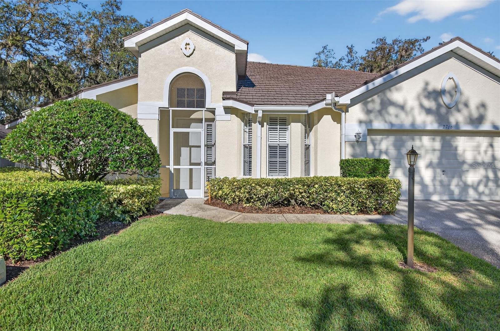 Unique single family detached "condo" in the highly sought after community Laurel Lake. Gracious foyer welcomes to this bright and open floor plan. Beautifully appointed with plantation shutters throughout the home. Spacious great room with dining/flex space, updated kitchen with nook. Primary bedroom features 2 walk in closets, updated en-suite bath with garden tub, separate shower and dual vanities. Enjoy the under roof lanai with extended screened patio. This home has been beautifully maintained by original owners. Kitchen updates feature custom cabinetry, granite and stainless appliances. Update primary bath includes new shower with no seam glass enclosure, classic cabinetry, granite and lighting. The unit has a high end aluminum metal roof and the A/C was replaced in 2025. Incredibly low $182.00 monthly fee includes lawn care, shrubbery, irrigation, tree trimming, private roadways, gated entry, escrow reserves and professional management. Located in the Walden Lake neighborhood featuring lakeside park, 6+ miles of trails, playground, fishing pier, sports complex and community dog park.