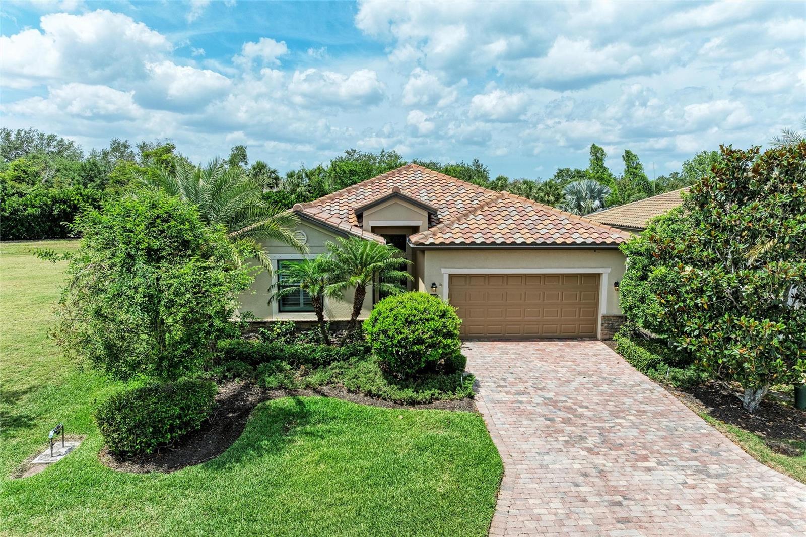 THE PERFECT HOME in the exceptional gated community of River Strand Golf & Country Club! This charming residence is everything you have been looking for to live your very best Florida life! The OPEN FLOOR PLAN of the Trevi model is a favorite, combining the main living areas into a large yet cozy space. The kitchen with custom backsplash and woodwork overlooks both the dining area and great room, perfect for everyday living as well as entertaining. This property also includes the den option, ideal for those working from home with double doors to add privacy and style. The original owners have created a warm and inviting home adding HARDWOOD FLOORING to the main living areas and den, newer carpet in the bedrooms, and custom closets in the guest bedroom and hall. A screened lanai with motorized sun shade sits off of the back providing a private spot to relax and take in the beautiful weather. You will love the spacious and light primary suite too, including a large en-suite and dual walk-ins, it is a true retreat. Two more guest bedrooms, one with it's own en-suite and the other next to the third full bath with newer shower and frameless glass doors complete the residence. This home features an attached 2 car garage and sits on a PREMIUM LOT, with added privacy due to the green space to one side and no neighbors to the rear. Your transferable SOCIAL MEMBERSHIP will allow you to experience Florida living at it's finest without the obligation of golf fees. Enjoy 2 community pools and spas, a clubhouse with RESTAURANT and grille room, tiki bar, 6 satellite pools, 2 fitness centers, tennis and pickleball courts and countless social events and activities! River Strand just keeps getting better and better with $8 million in improvements to the Clubhouse, Tiki Bar and Pool area scheduled for completion this year. Perfectly located just minutes from the new Marketplace and I-75 and close to those beautiful Gulf Beaches too! So make this one your next place to call home and come and experience River Strand at it's best, you may never want to leave!