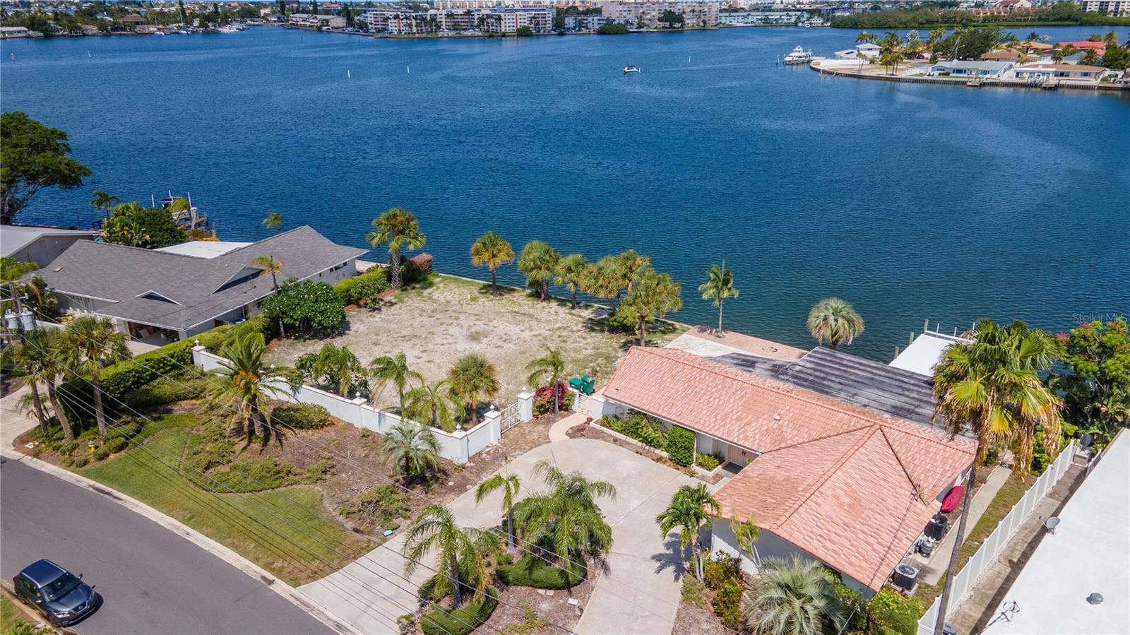 Under contract-accepting backup offers. If you are looking for waterfront property, your search is over! This property is being sold as a package with the adjacent house. Please see MLS # U8250458. Your options are endless: you can live in the existing house and build on the adjacent lot, knock down the current house and combine both lots for a larger estate, or build on both lots. The seller will not be making any upgrades, as the property is being sold as-is. The sunsets from your back patio are breathtaking, offering a perfect end to each day. The seawall on each lot is approximately 93 feet & 5 inches long.