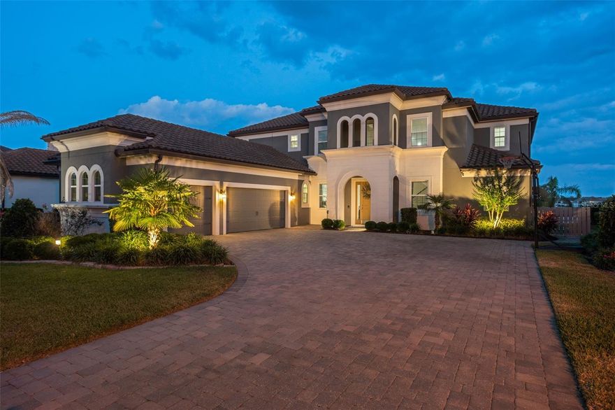 Welcome to  an unparalleled opportunity to embrace the beauty of Central Florida's waterfront lifestyle!  Enjoy the mesmerizing views over dancing waters from the coveted shores of Lake Hancock.  Designed with both luxury and functionality in mind, this exceptional residence features six bedrooms and five-and-a-half bathrooms, providing ample space for family living and entertaining guests in style. With living spaces and master suites on both the upper and lower levels, there's plenty of room for lounging and relaxing.   Serving up the best of south facing long lake views and nightly Disney fireworks in the highly sought Hamlin locale, where dining and everyday conveniences are just around the corner.  
The screened lanai encompasses a resort-style pool with a designated lap lane and an outdoor kitchen, complete with a woodchip burning grill and smoker and wine refrigerator.  The lanai opens to the elevated cornhole sandpit and boat dock berth.  For those who love to take to the water, a private boat dock awaits, complete with lights and an electric lift, providing easy access to Lake Hancock's shimmering waters.  Lake Hancock is an extraordinary three lake chain of lakes that is ideal for fishing and water sports, or for cruising the lake at sunset.  Pristine calm waters and miles of shoreline await your adventures and exploration.  Overlook at Hamlin is a neighborhood of dreams that includes a state-of-the-art lakeside clubhouse and fitness center, resort-style pool, and basketball courts.  The community also offers a private boat ramp to launch on Lake Hancock, and kayaks for use.  Future plans include a boat-to marina landing for access to Hamlin's shops and restaurants.