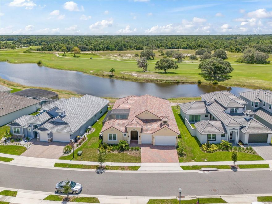 Ideally situated in Hampton Landing within the luxurious PROVIDENCE GOLF COMMUNITY, this spacious single-story, immaculately presented COURTYARD RESIDENCE sits on a PRIME LOT with both WATER AND GOLF VIEWS and benefits from no rear neighbors. Built in 2023 by ABD Homes, this residence features 4 bedrooms, 3/1 bathrooms, a 3 car garage and PRIVATE POOL set in a large courtyard patio area pre-plumbed for a summer kitchen. At the heart of the home is the expansive OPEN PLAN CONCEPT kitchen and family room with plenty of natural light which flows into an informal sunlit breakfast/ dining nook. The GOURMET KITCHEN is a chef’s dream with upgraded Samsung appliances, ample cabinetry, sprawling central island with seating, quartz countertops, stove top, tile backsplash and walk-in pantry. Exuding luxury in a modern setting, the property also includes a welcoming foyer area, formal dining room / versatile living area with tray ceiling, conveniently located laundry room and separate guest powder half bath serving the living room areas. The primary bedroom is a well-appointed, true retreat with views of the pool and has a large walk in closet and impressive ensuite bathroom consisting of separate vanities, a walk-in shower and soaking tub centerpiece. Each of the other three further bedrooms are well-proportioned with well sized closet spaces. The fourth bedroom is a SEPARATE GUEST/IN-LAW bedroom suite with full ensuite bathroom and overlooks the pool & courtyard. DESIGNER FINISHES include a long-lasting tile roof, high ceilings, wood plank-style tile flooring, elegant light fixtures, soft close cabinetry and energy-efficient French doors and double paned windows together with stylish window dressings. Seamlessly blending the outdoor with the indoor, enjoy Florida lifestyle living either lounging under the shade of the expansive covered patio area enjoying the golf & water views or unwinding in the sparkling pool with CASCADING WATER FEATURES in the private enclosed courtyard. Providence is a 24 hour guard gated 18-hole golf course community offering many amenities including a Pro Shop, restaurant, resort-style pool with waterslide, lap pool, tennis courts, playgrounds, fitness center and walking trails. In close proximity to major highways/roads, local shopping malls and entertainment as well as the theme parks and Orlando International Airport. Don’t miss out on this exquisite gem, BOOK YOUR VIEWING TODAY!