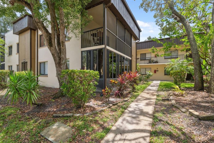 First floor 2bed/2bath condo located in the desirable Raintree Village community. Reserved parking spot 2-09A is located directly in front of the unit. Tile floors in kitchen and bedrooms, real hardwood floors in living room. Eat-in kitchen with all appliances included. Primary suite has large walk-in closet and private bath with tiled walk-in shower. Second bedroom with sliding doors that leads to glass enclosed patio and laundry room with full size washer and dryer. This quiet community boasts 3 Pools, tennis court, racquetball court, and club house available to rent for events. Raintree Village is located off Fowler Ave and a 5-minute drive to USF campus.